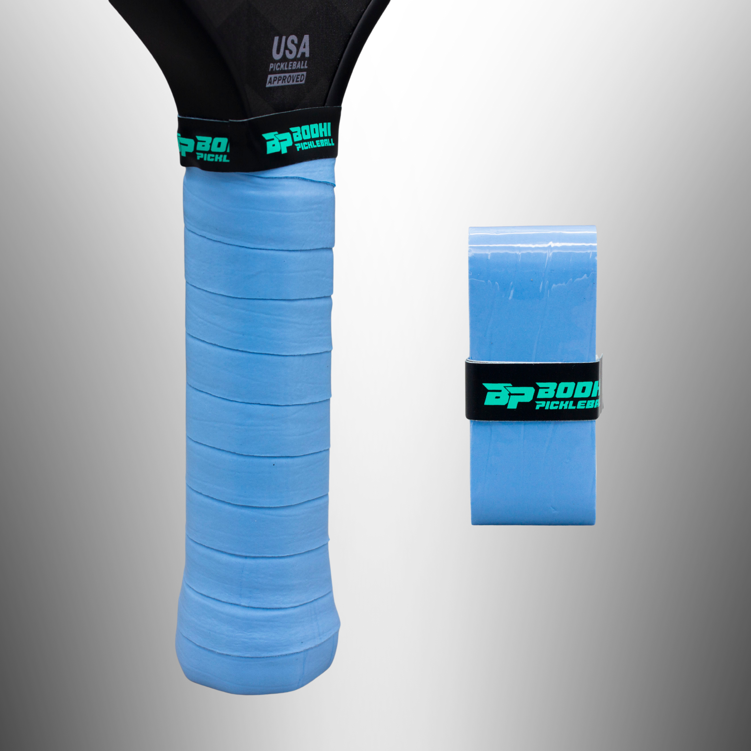 Light blue PROtack Overgrips by Bodhi Pickleball, one wrapped on a paddle handle, another as a packaged roll.