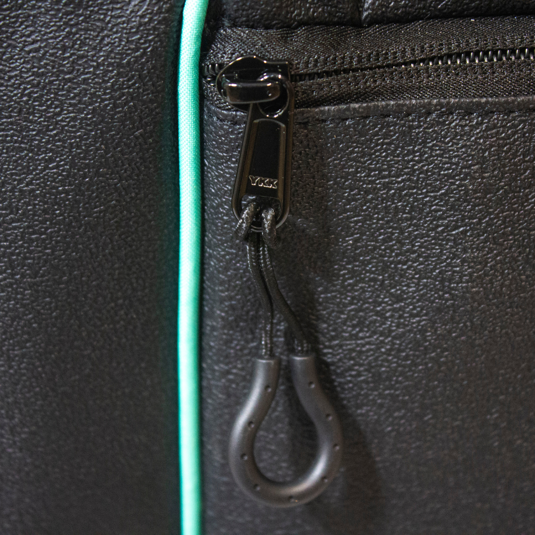 Black duffle bag by Bodhi Pickleball with textured material, YKK zipper, and teal piping.