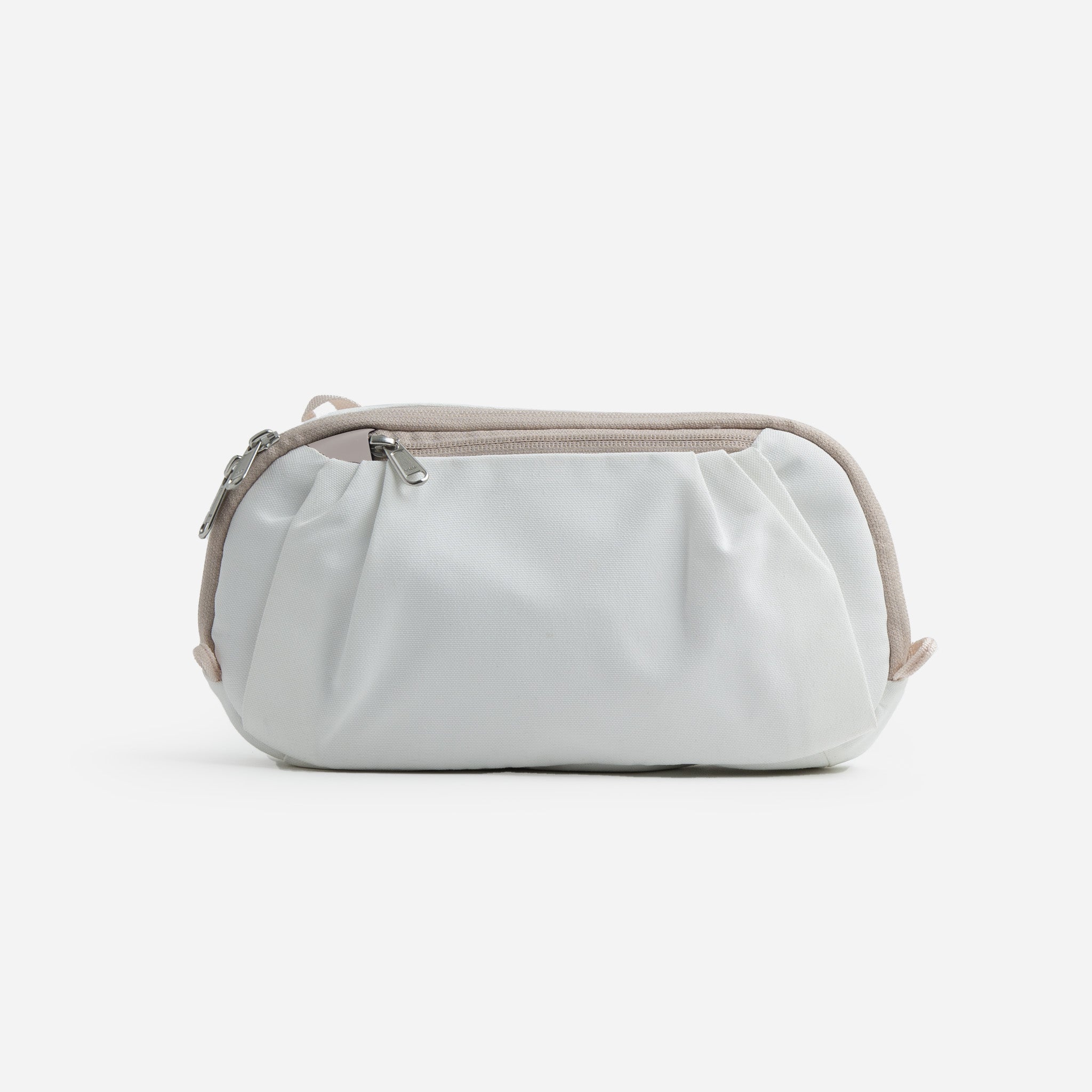 White cosmetic bag with light brown trim and silver zippers.