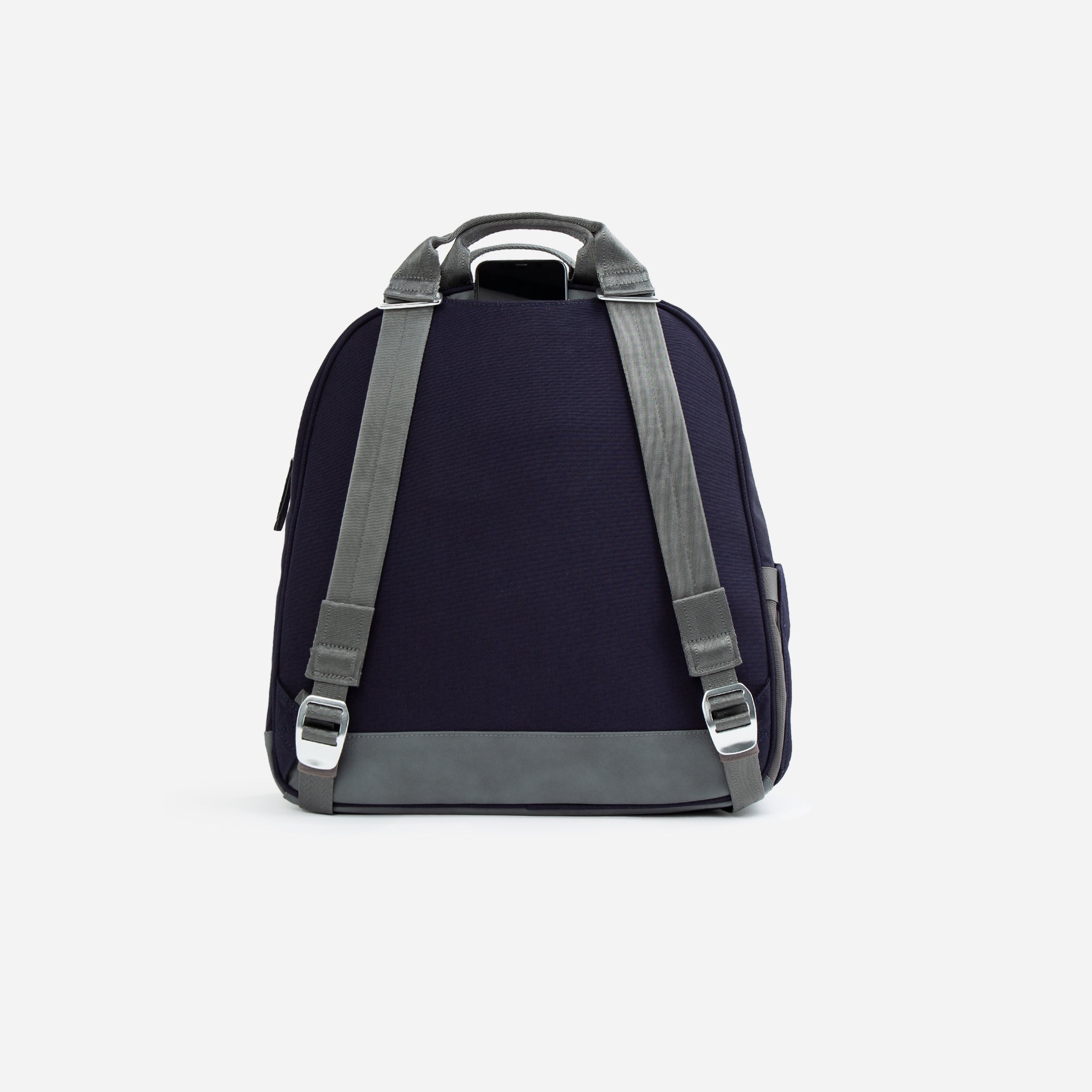 Back view of a navy blue and grey fabric tennis backpack by Doubletake, with adjustable straps, a top handle, and a phone peeking from a top pocket.