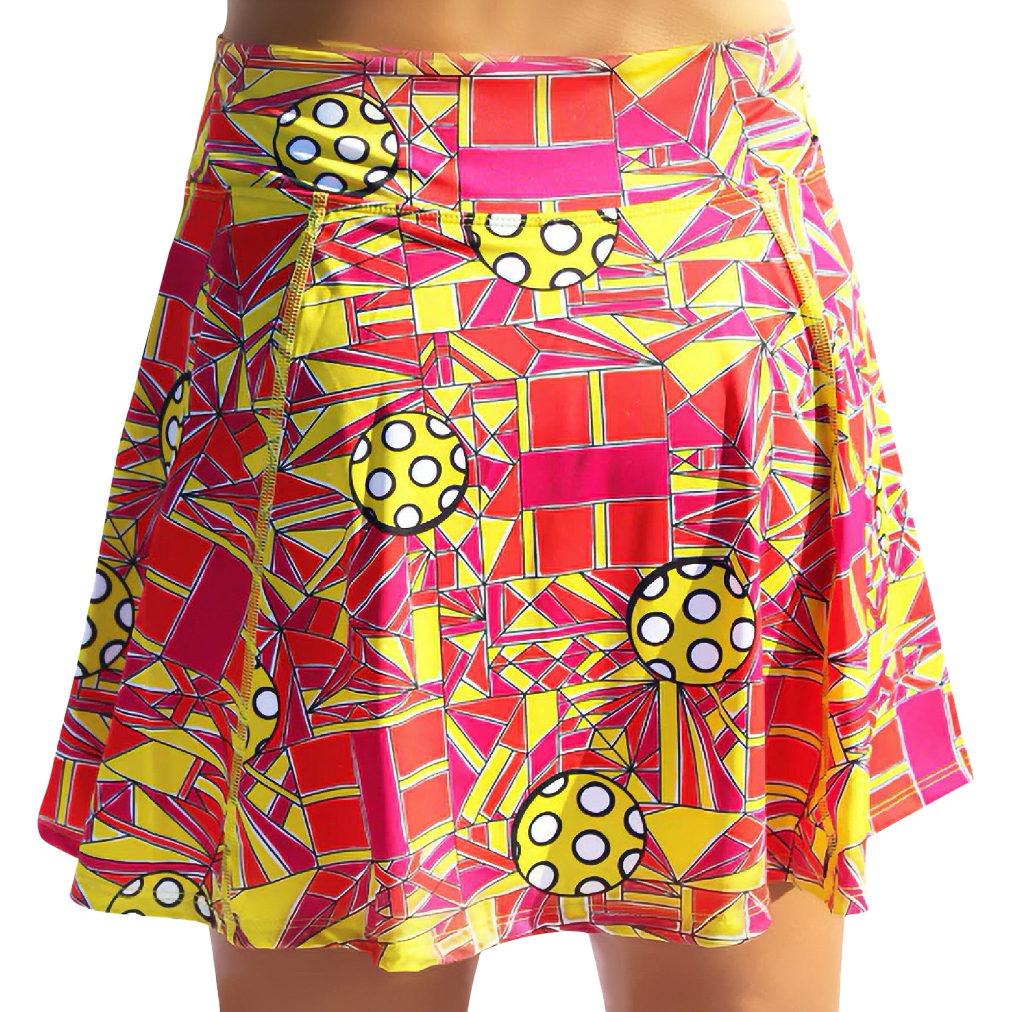 Vibrant A-line skort by Pickleball Bella with a red, yellow, and pink geometric pattern and pickleball-like polka dot circles.