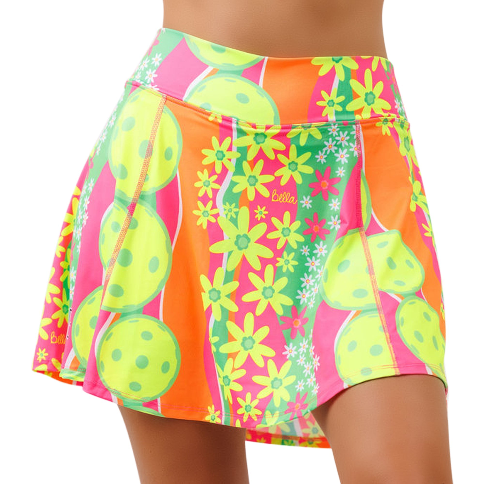 Vibrant multi-colored A-line skort by Pickleball Bella, with daisy flowers and pickleball designs, shown on a model from the front.