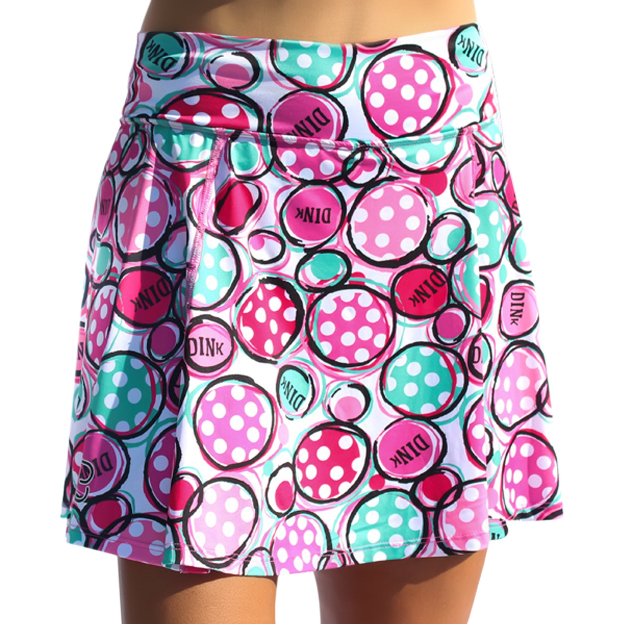 Pink and teal A-line skort by Pickleball Bella with polka dot and 'DINK' text circles on a white background.