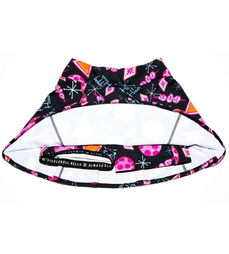 Black A-line skort with martini, 2-4-1, and happy hour pattern by Pickleball Bella, shown from underneath revealing white lining and inner pocket.