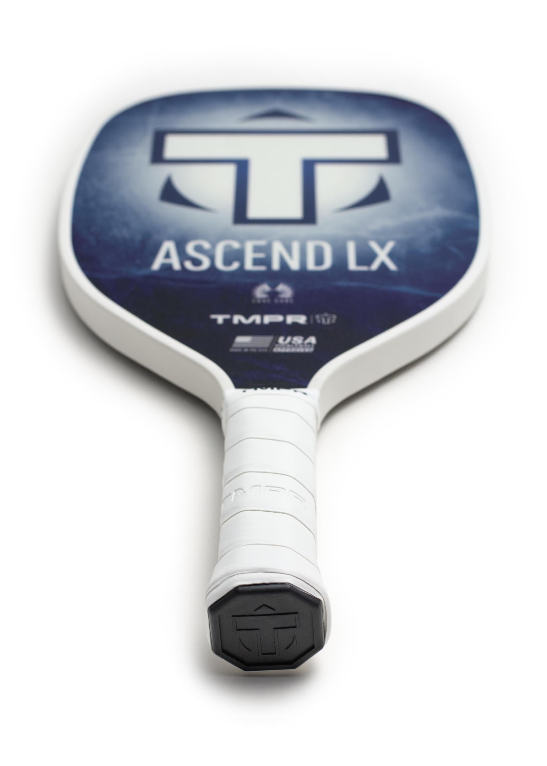 Indigo Ice pickleball paddle by TMPR Sports with a white grip and black logo end cap, viewed from above.