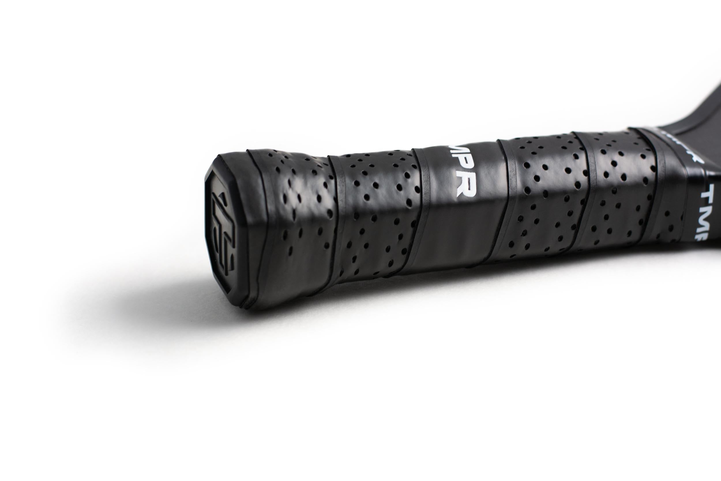 Black perforated pickleball paddle grip by TMPR Sports with visible logo and butt cap.