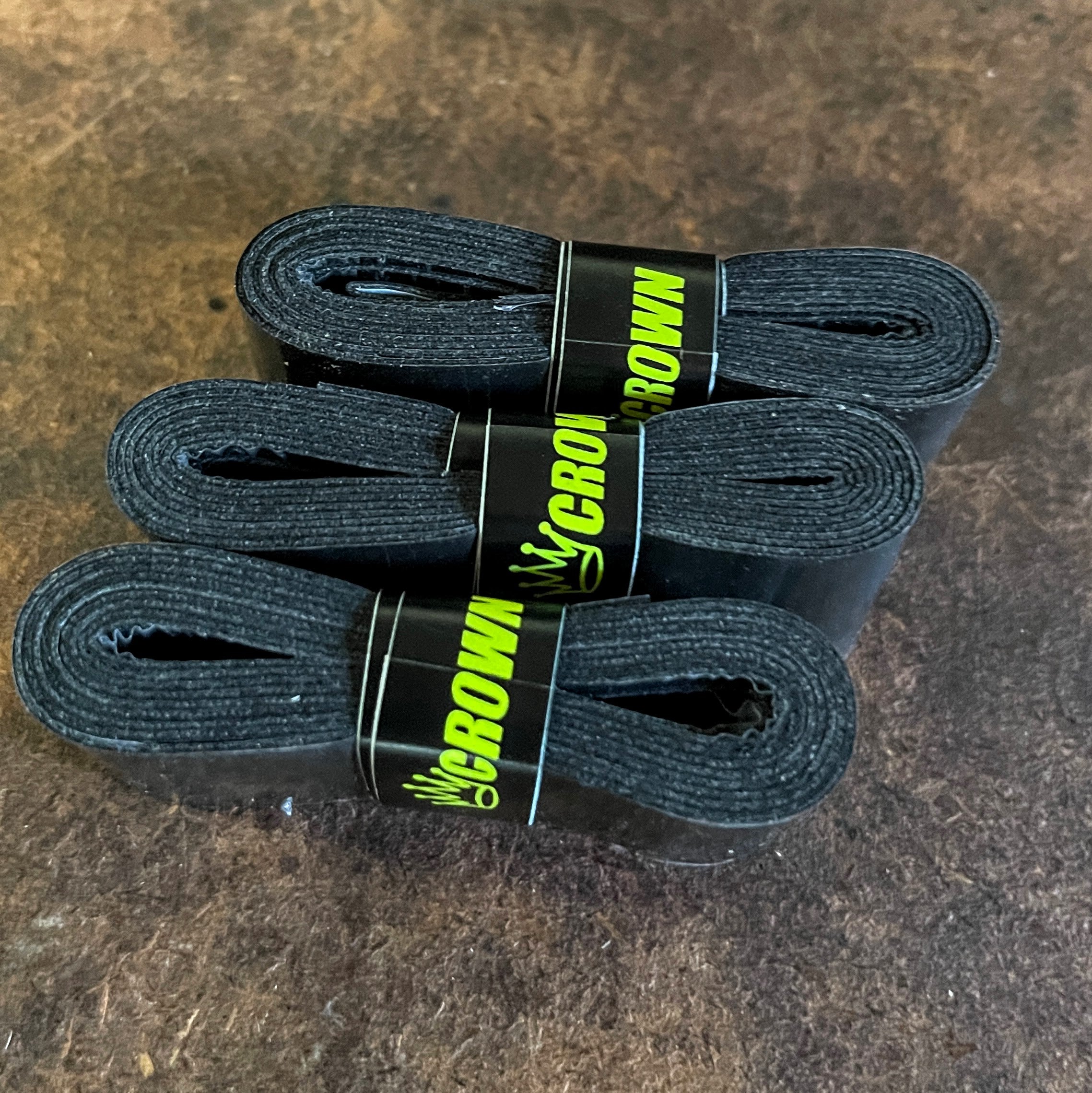 Three rolls of black Crown grip tape.