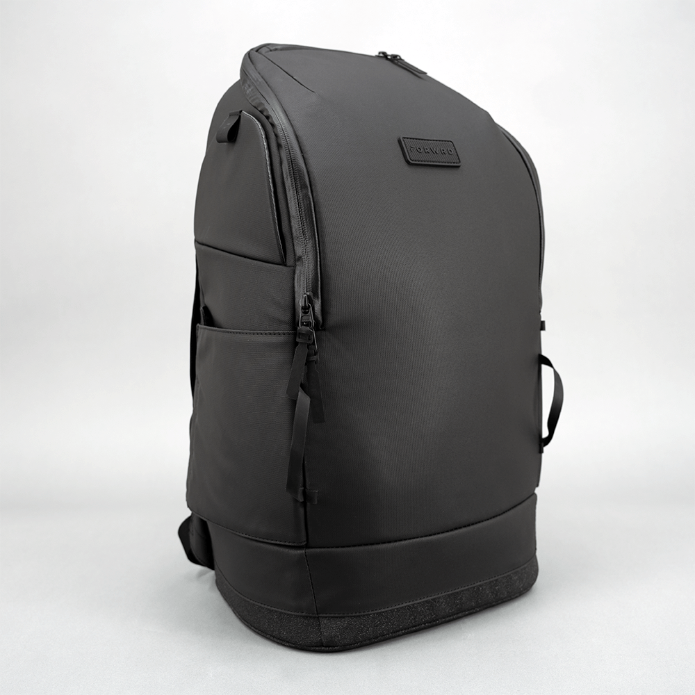 Dark grey pickleball bag by FORWRD, featuring a subtle logo, zippered compartments, and a textured base, viewed from the side.