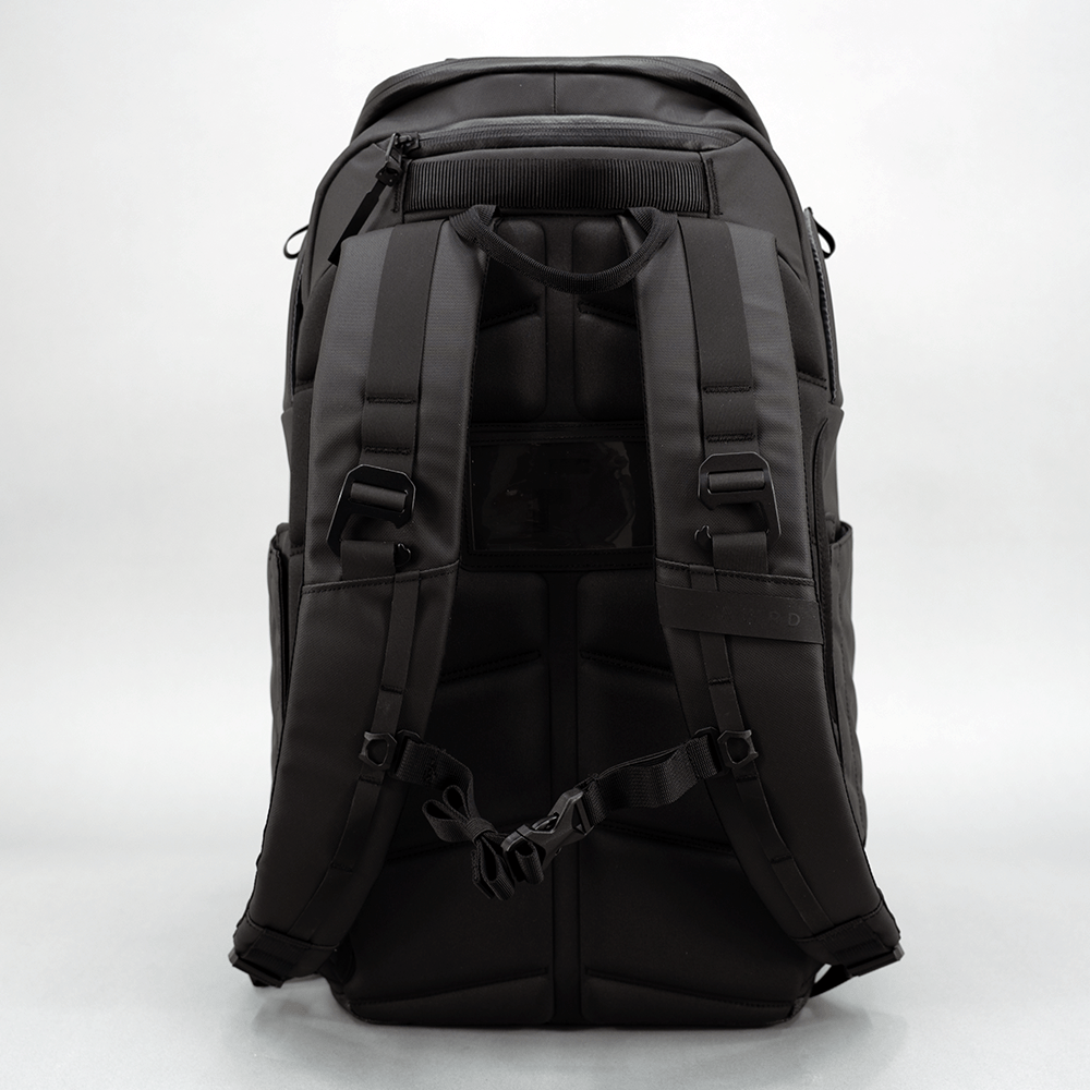 Black pickleball backpack by FORWRD, shown from the back with a padded back panel, adjustable shoulder straps, and chest strap.