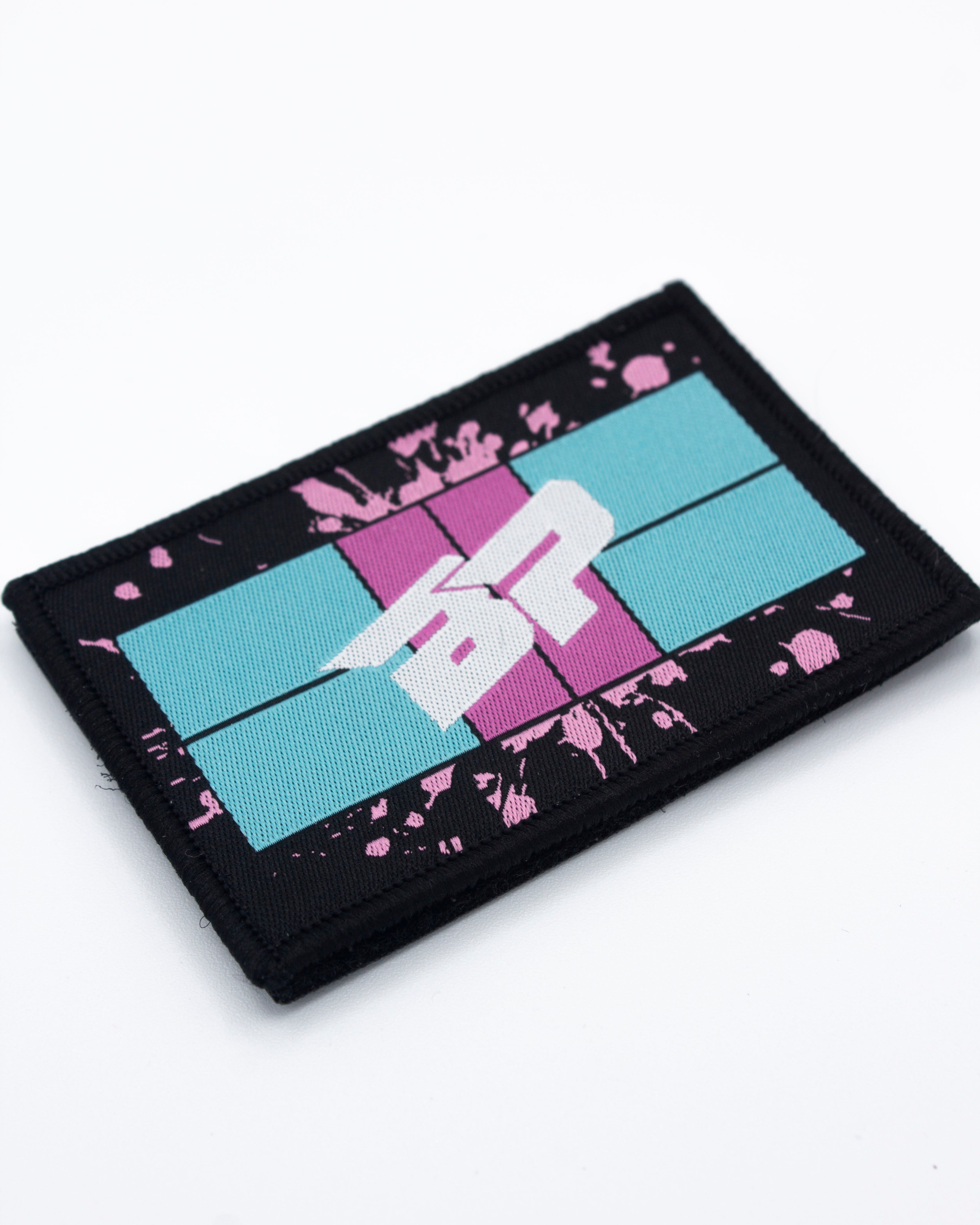 Black rectangular Velcro patch by Bodhi Performance with a blue and pink retro grid graphic, white '4R' text, and pink paint splatters.