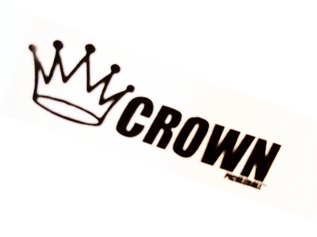 Close-up of a white wristband with a black crown illustration and the word "CROWN" in black lettering.