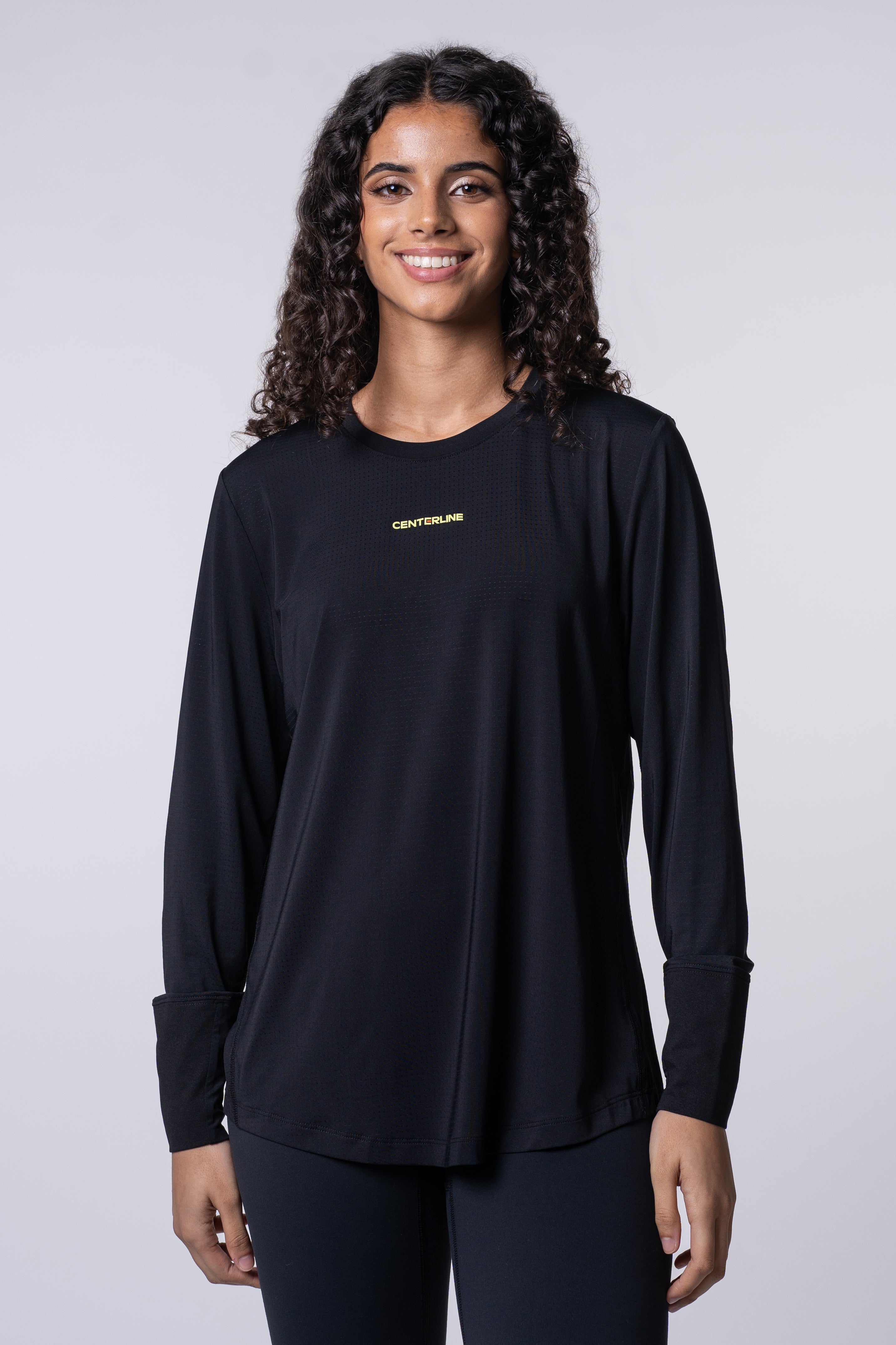 Woman in black long-sleeved shirt and leggings.