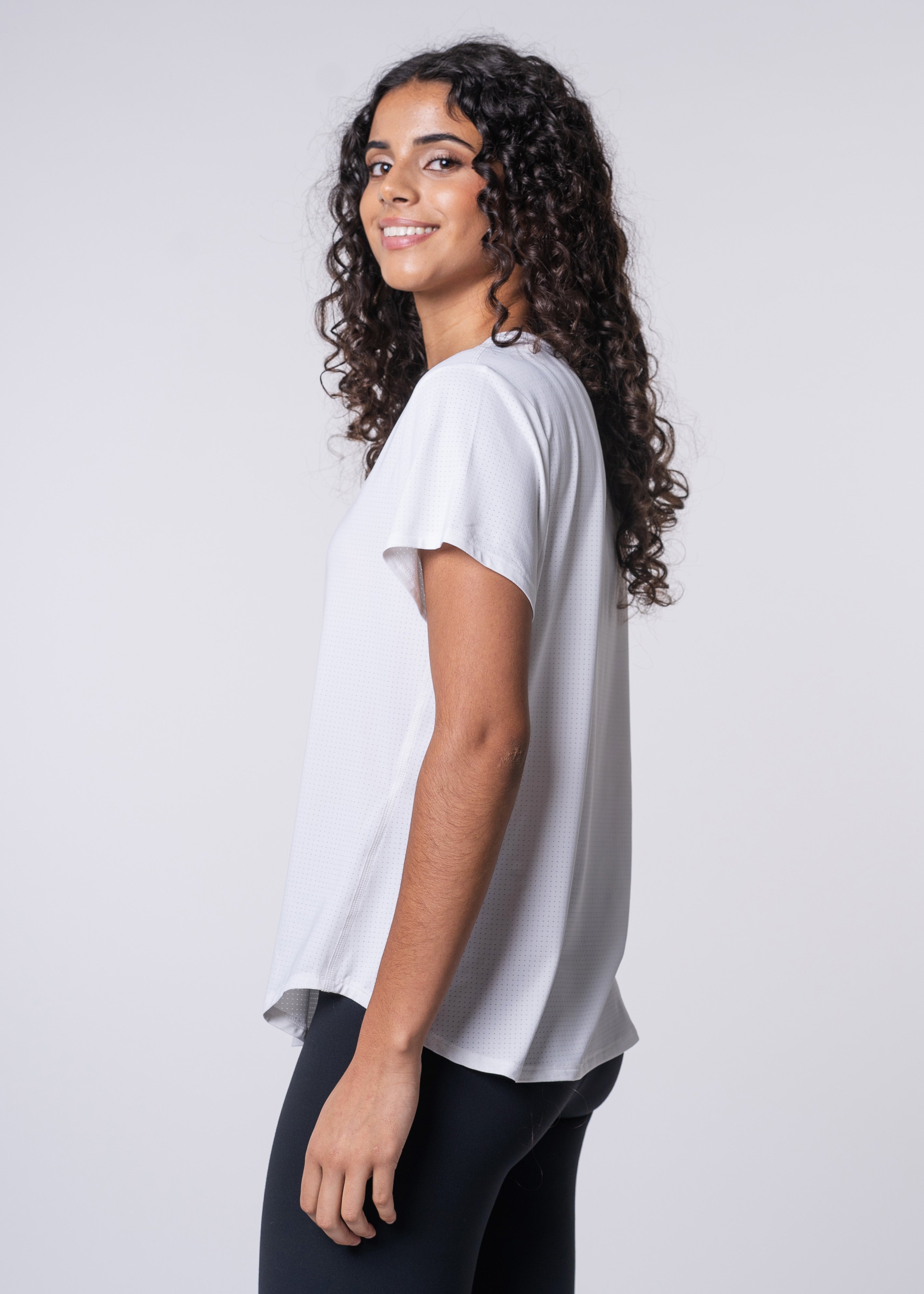 Woman in white t-shirt and black leggings.