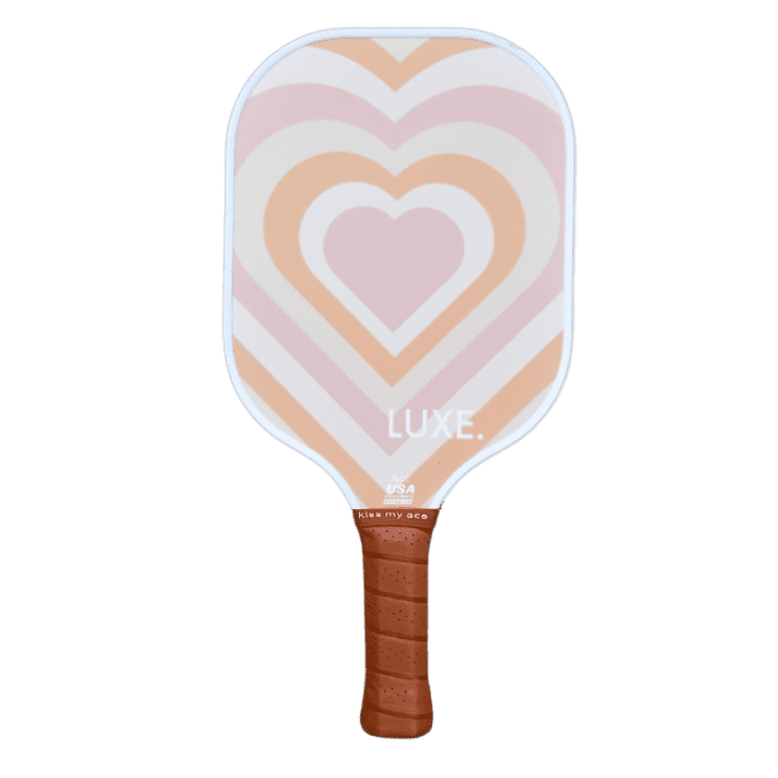 A pickleball paddle with a heart design and a brown grip.