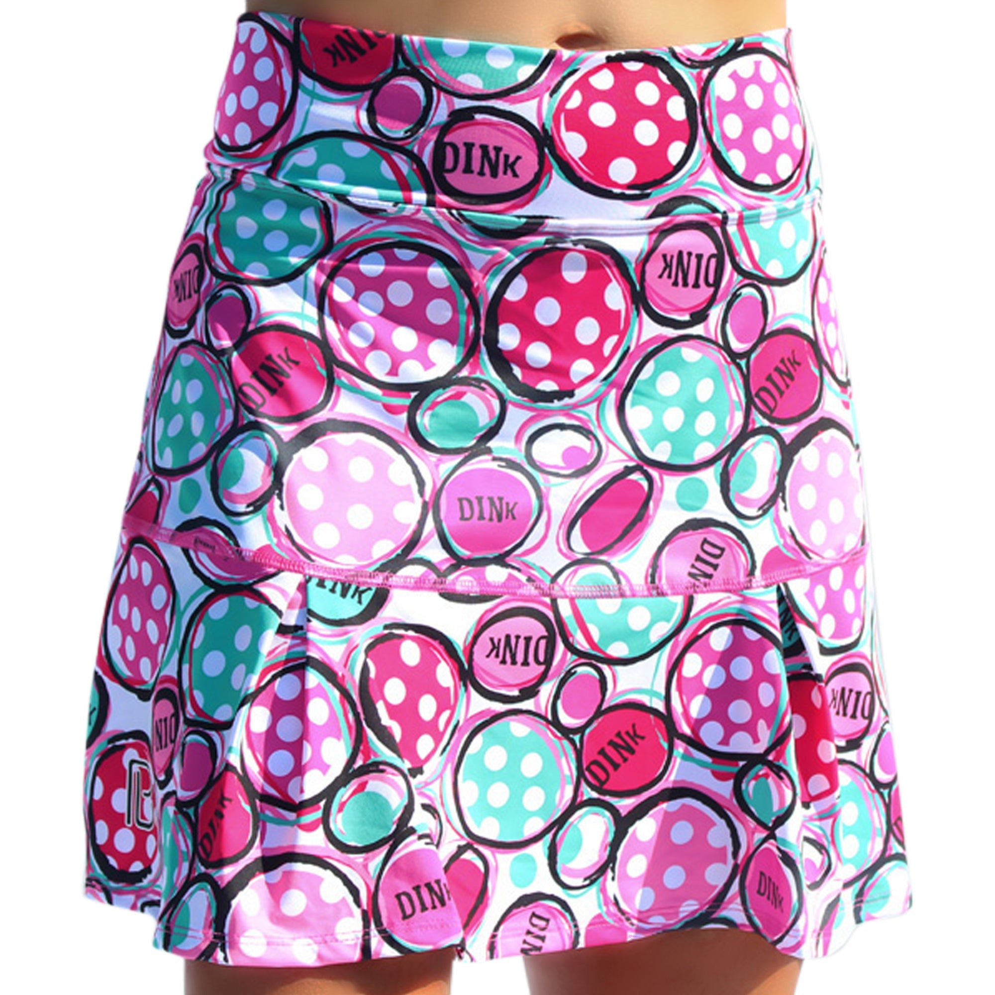 Vibrant patterned pleated skort by Pickleball Bella, featuring pink and aqua polka-dotted circles and 'DINK' text.