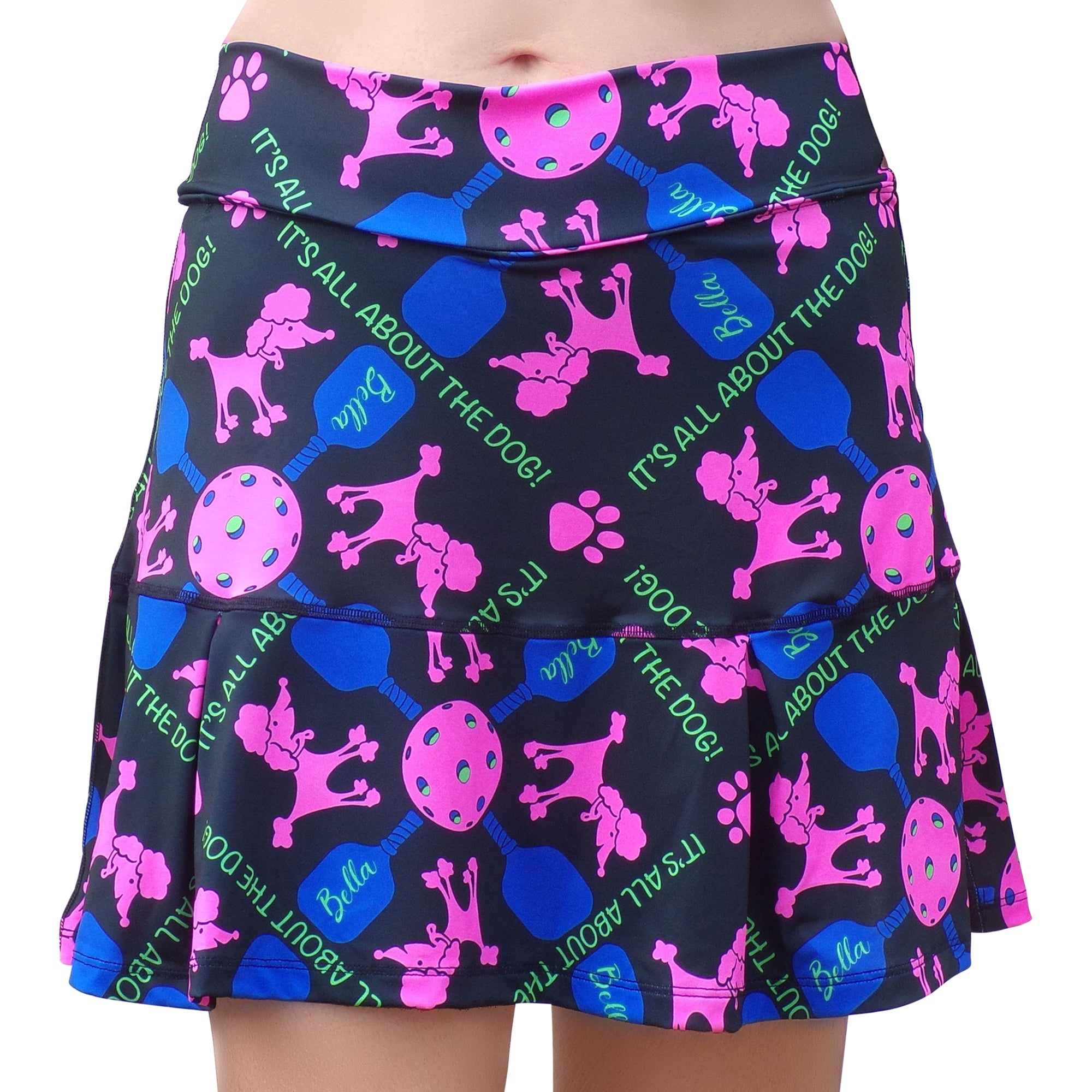 Black drop pleat skort by Pickleball Bella featuring pink poodles, pickleball equipment, and 'IT'S ALL ABOUT THE DOG!' text.