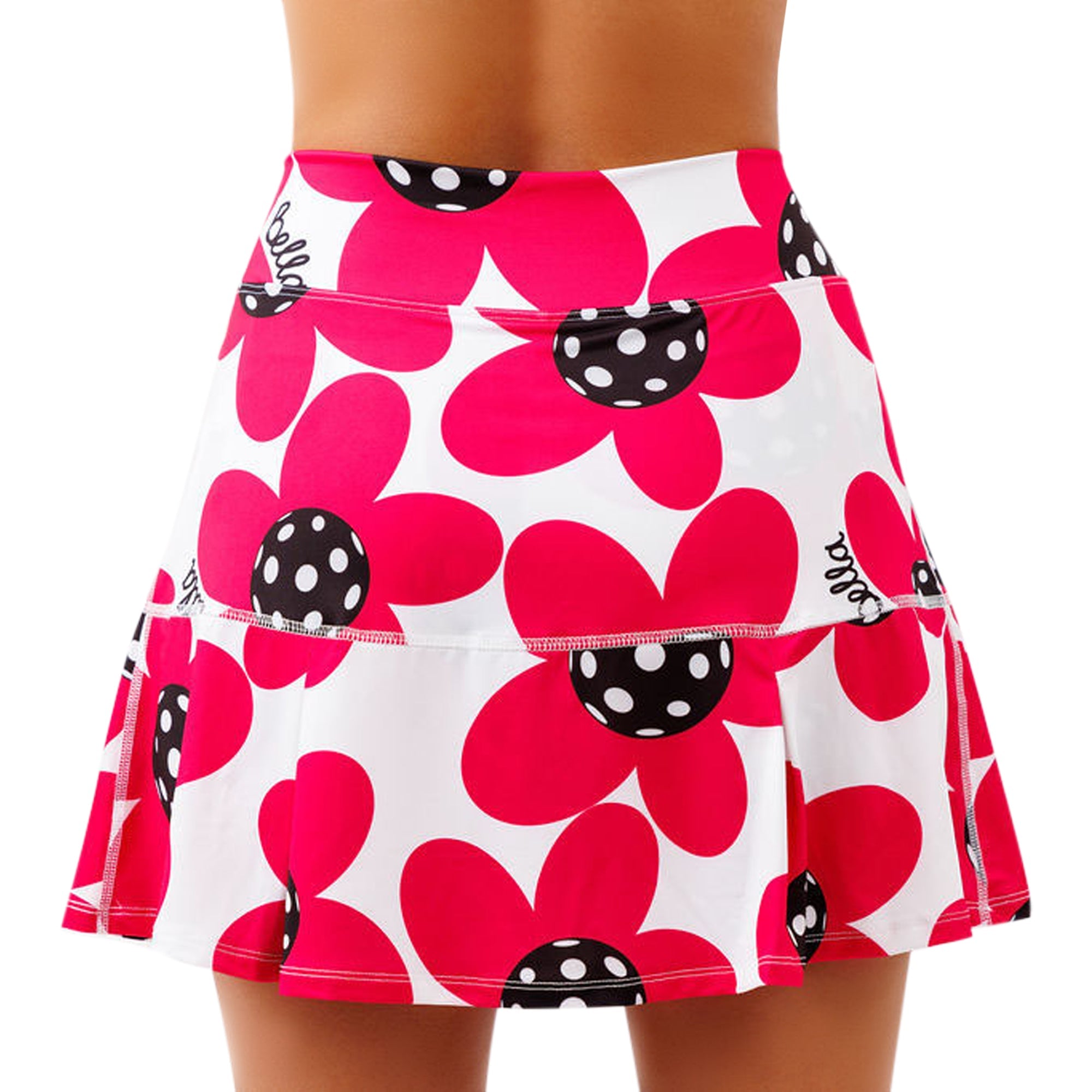 White and poppy red drop pleat skort by Pickleball Bella, worn on a person's back, featuring large floral patterns with black polka-dot centers and 'Bella' script.