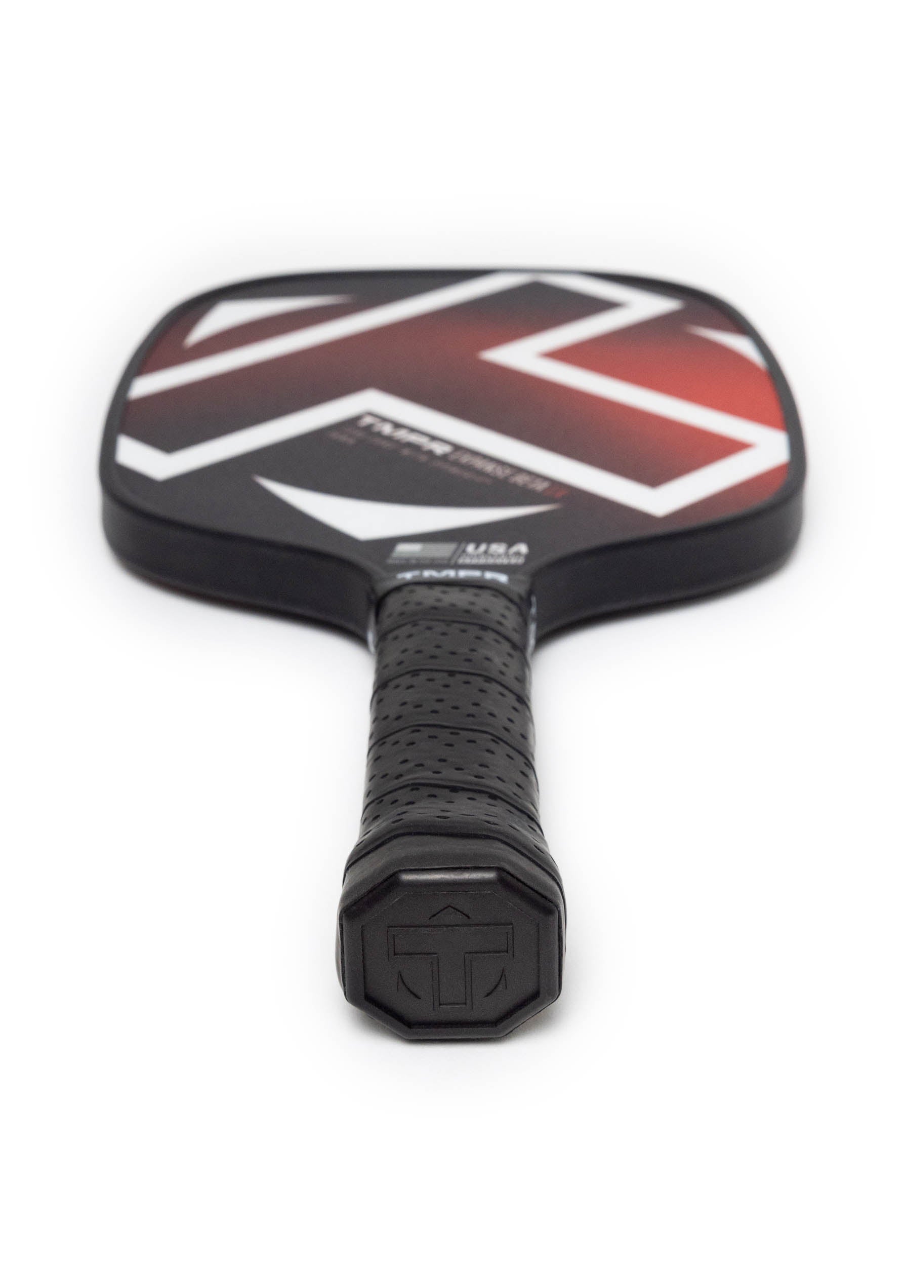 Black and red pickleball paddle from TMPR Sports with white abstract design and a black textured grip, viewed diagonally.