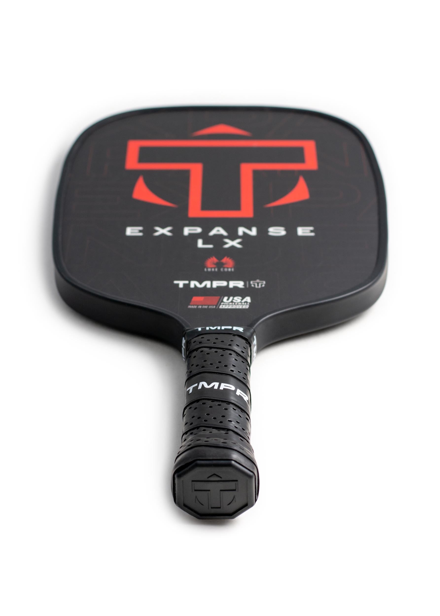 Black pickleball paddle by TMPR Sports with a red 'T' logo, 'EXPANSE LX' text, and a perforated grip.