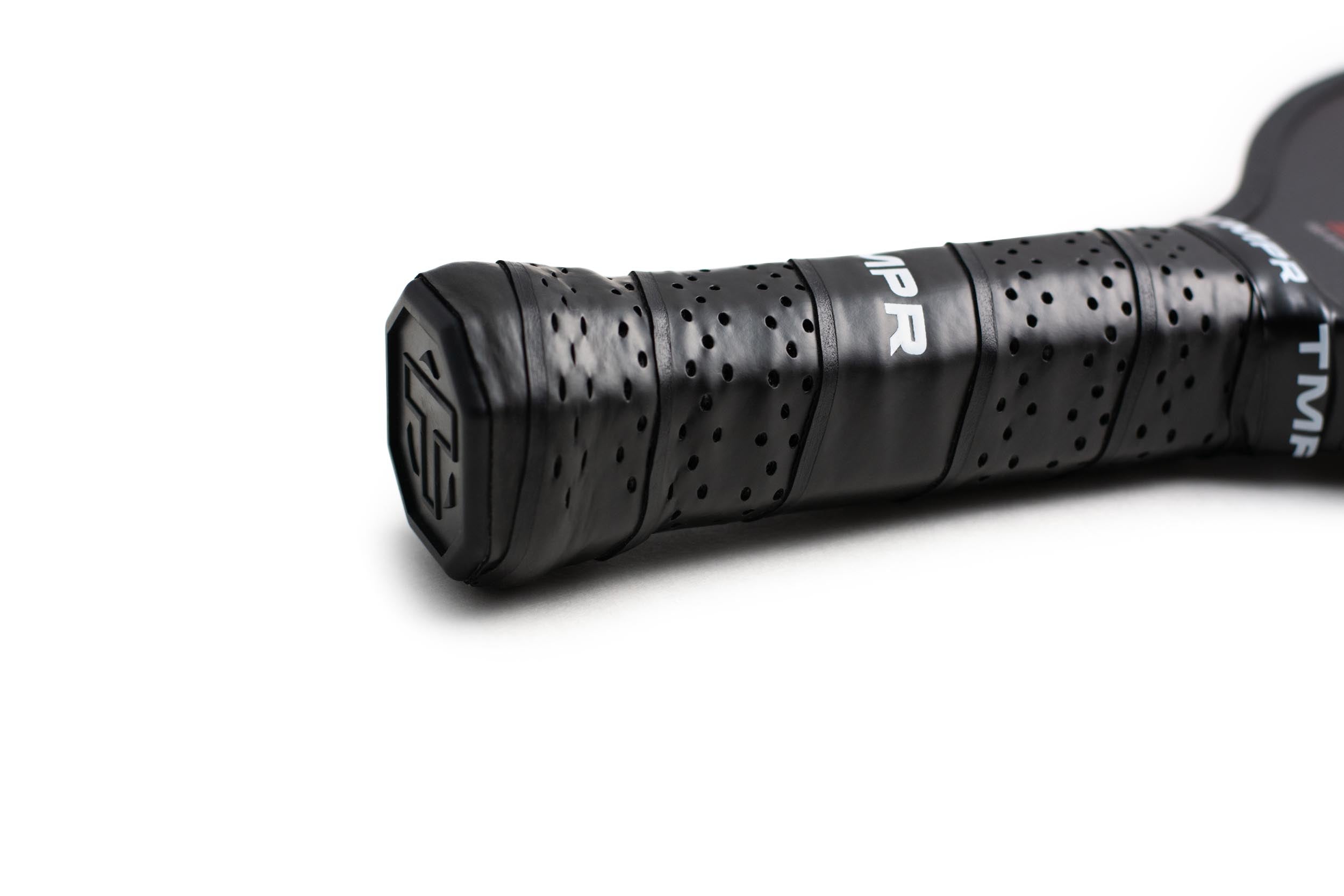 Black pickleball paddle handle by TMPR Sports with a perforated grip, showing 'MPR' text and end cap logo.