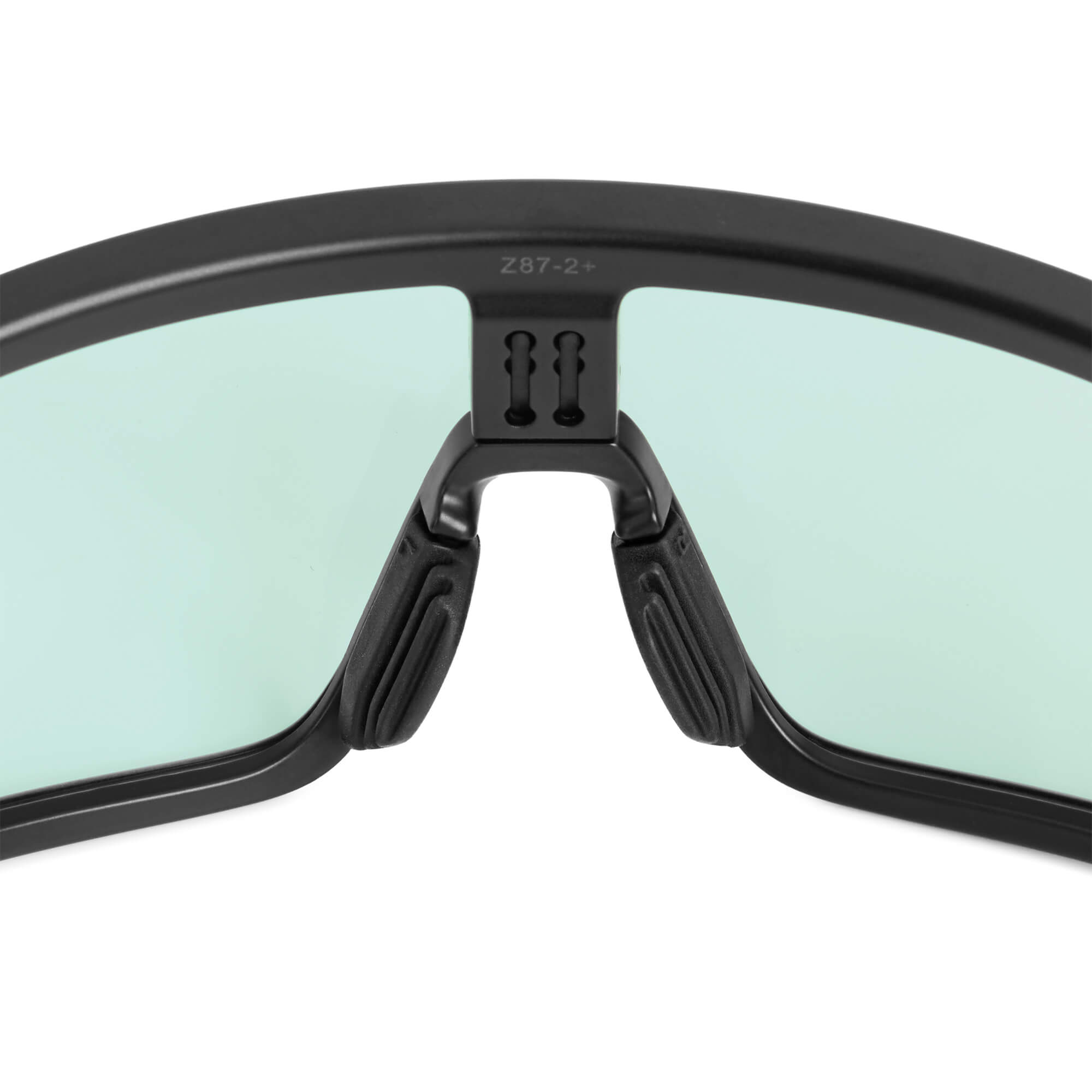 Black textured nose pads by BRIOTI, on black framed glasses with light green lenses and 'Z87-2+' marking.