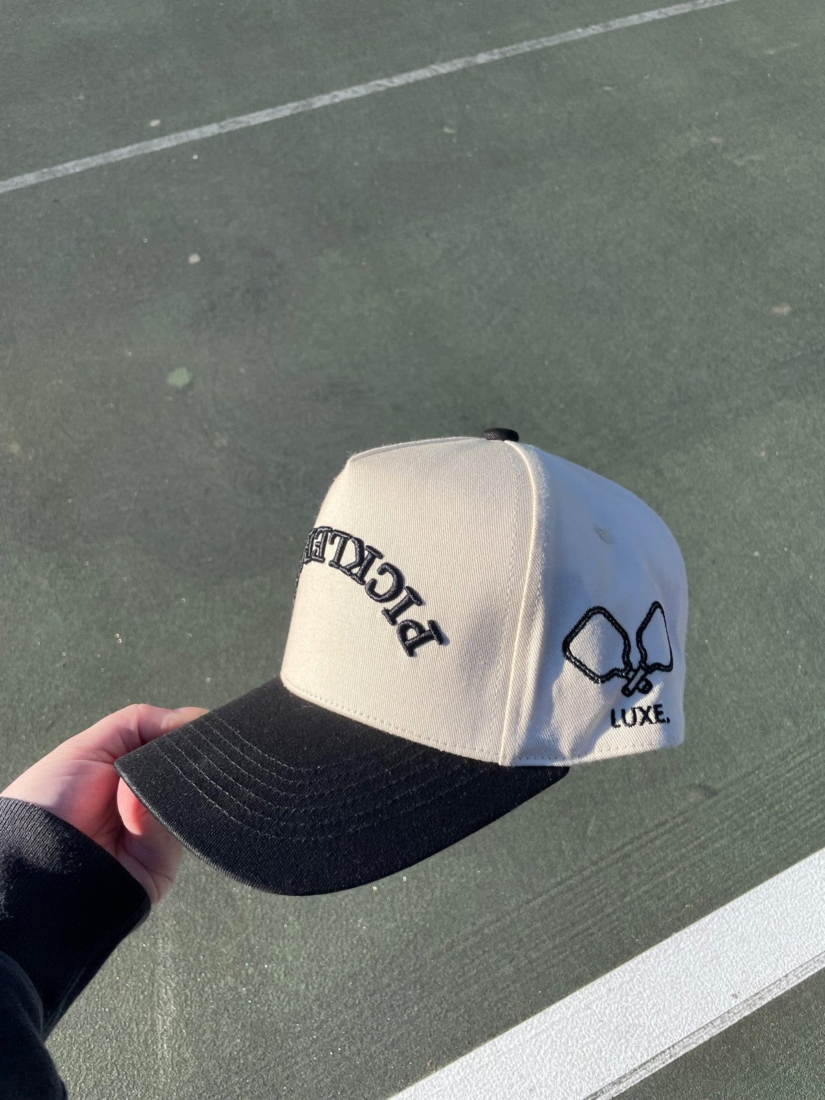 Tan and black baseball cap with "PICKLE" embroidered on the side.