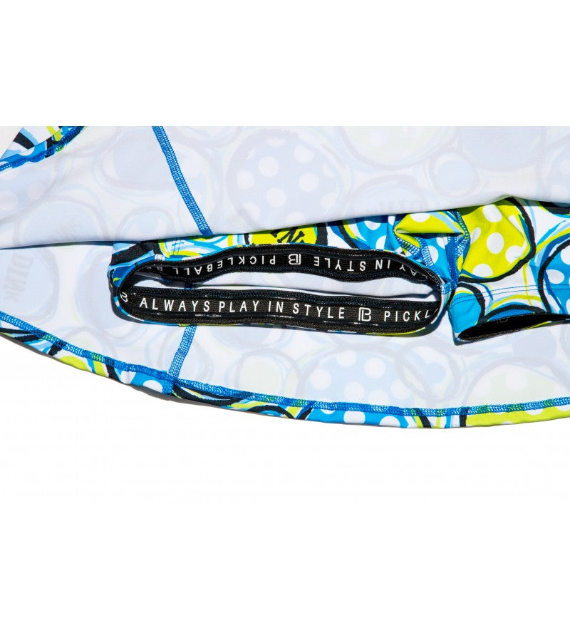 Blue, yellow, white A-Line Skort by Pickleball Bella, with pickleball pattern and inner "ALWAYS PLAY IN STYLE" waistband.