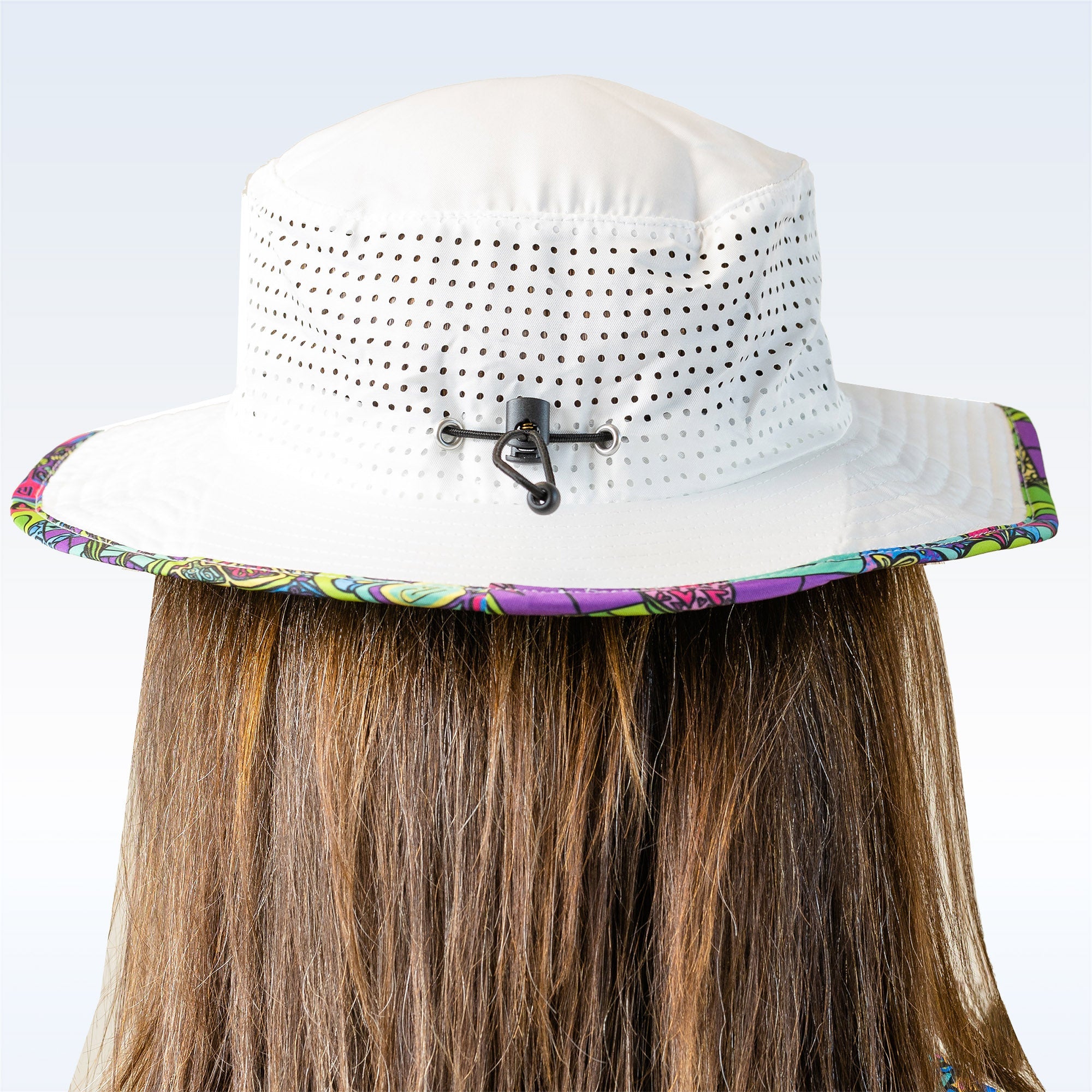 White mesh-sided Pickleball Bucket Hat by Pickleball Bella, featuring a vibrant patterned brim and back cord adjuster, seen from behind.