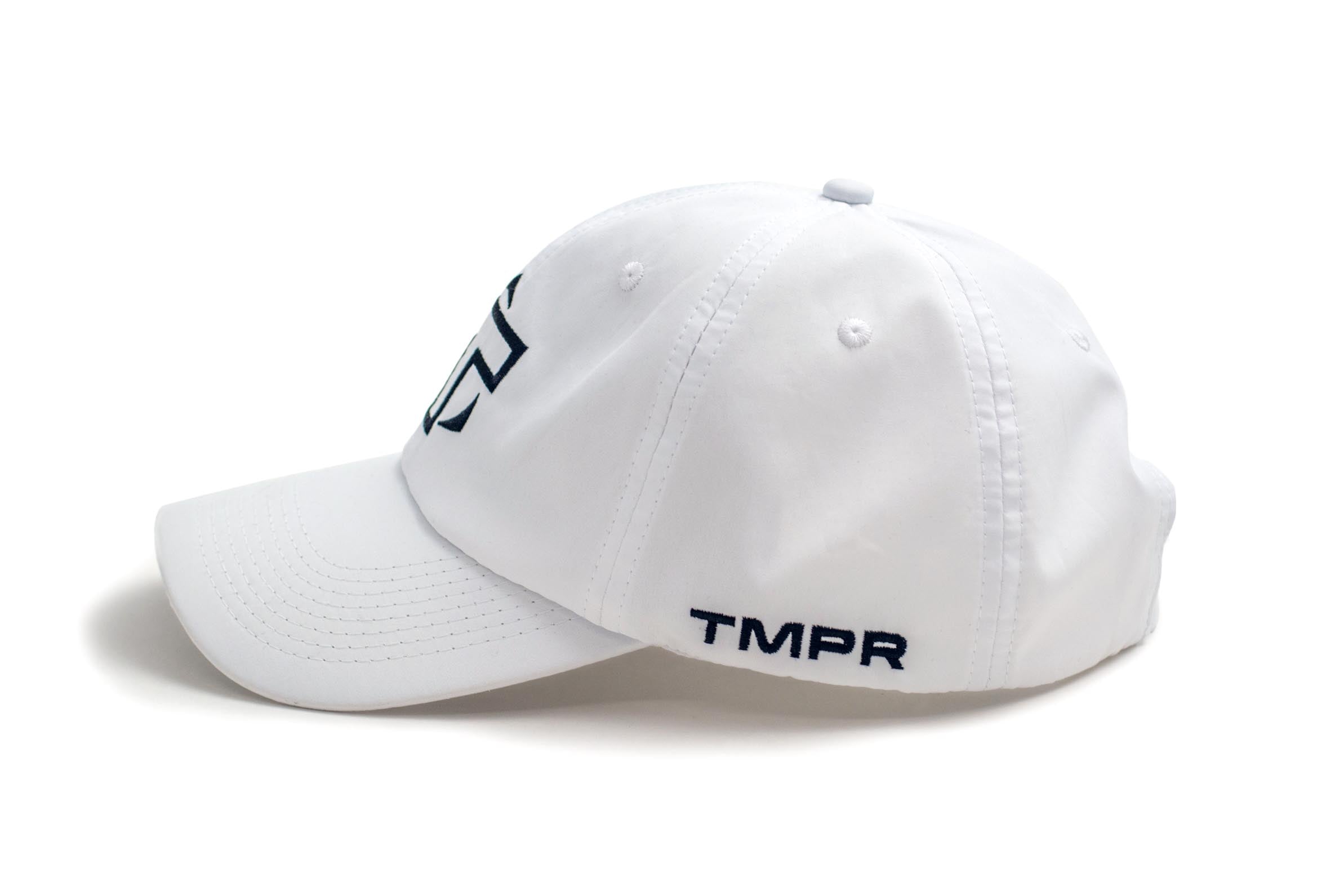 White Performance Cap by TMPR Sports featuring a black 'T' logo on the front and 'TMPR' text on the side, viewed from the side.