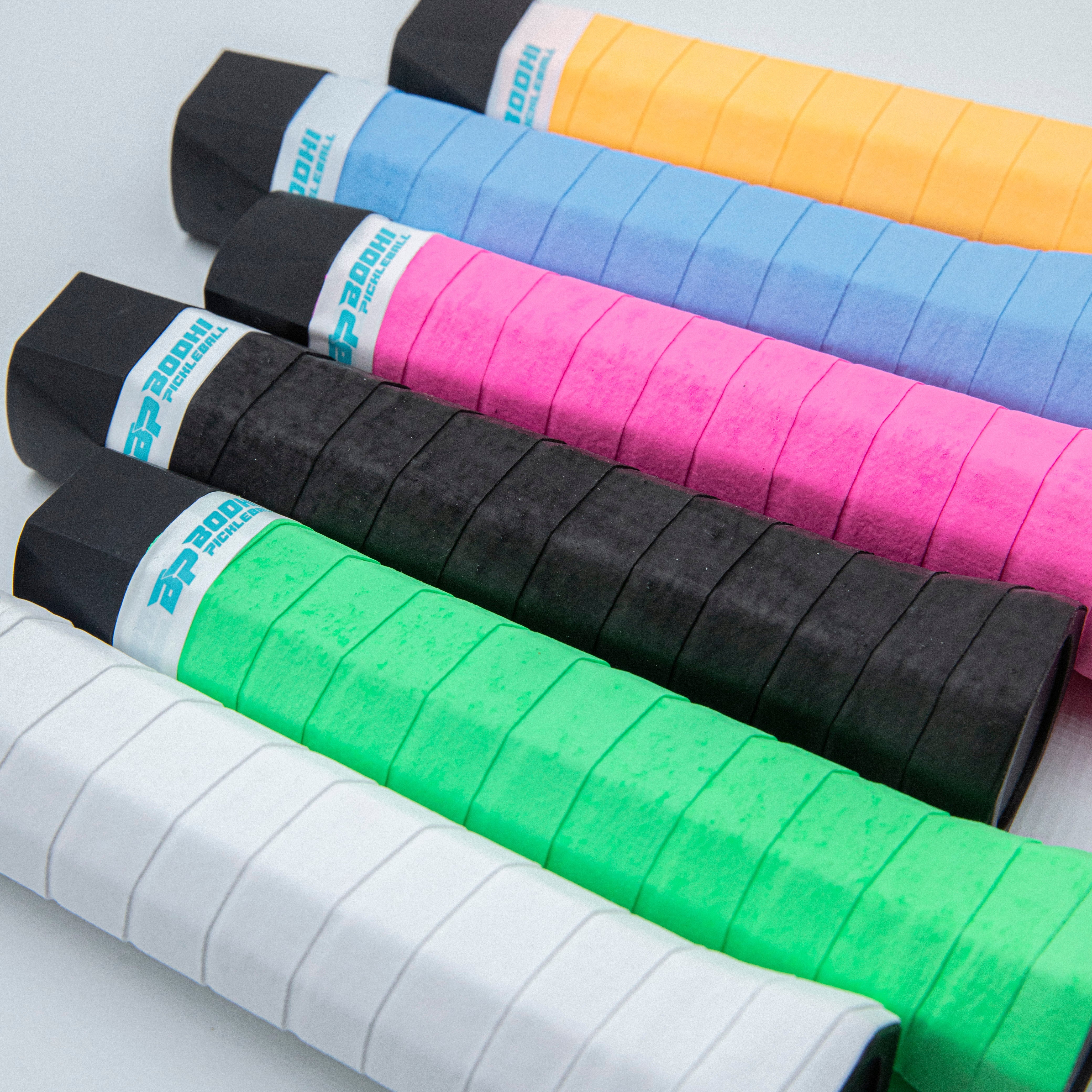 Six colorful pickleball paddle grips.