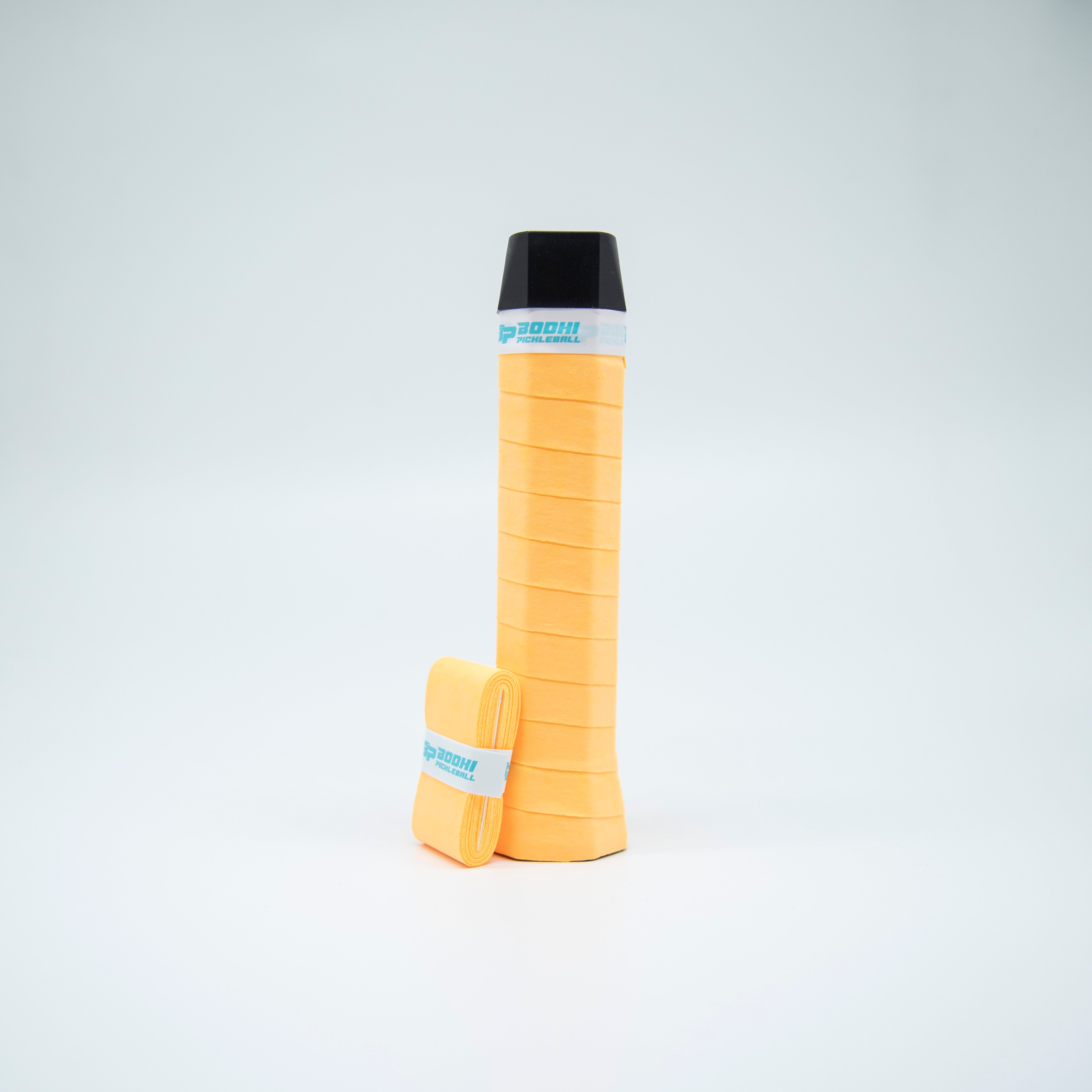 A yellow pickleball paddle grip and wrapped replacement grip on a white background.