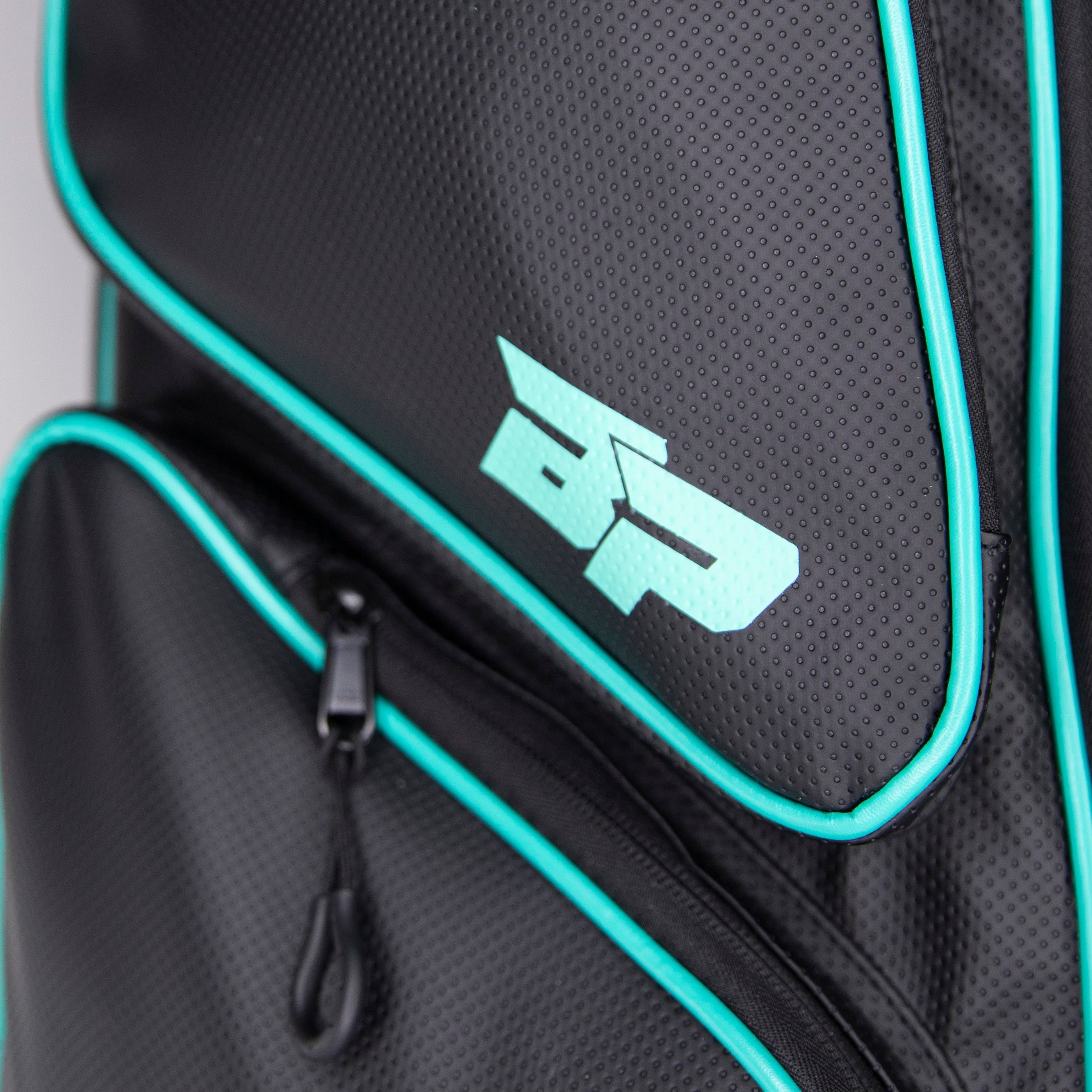 Close-up of a black and teal patterned bag.