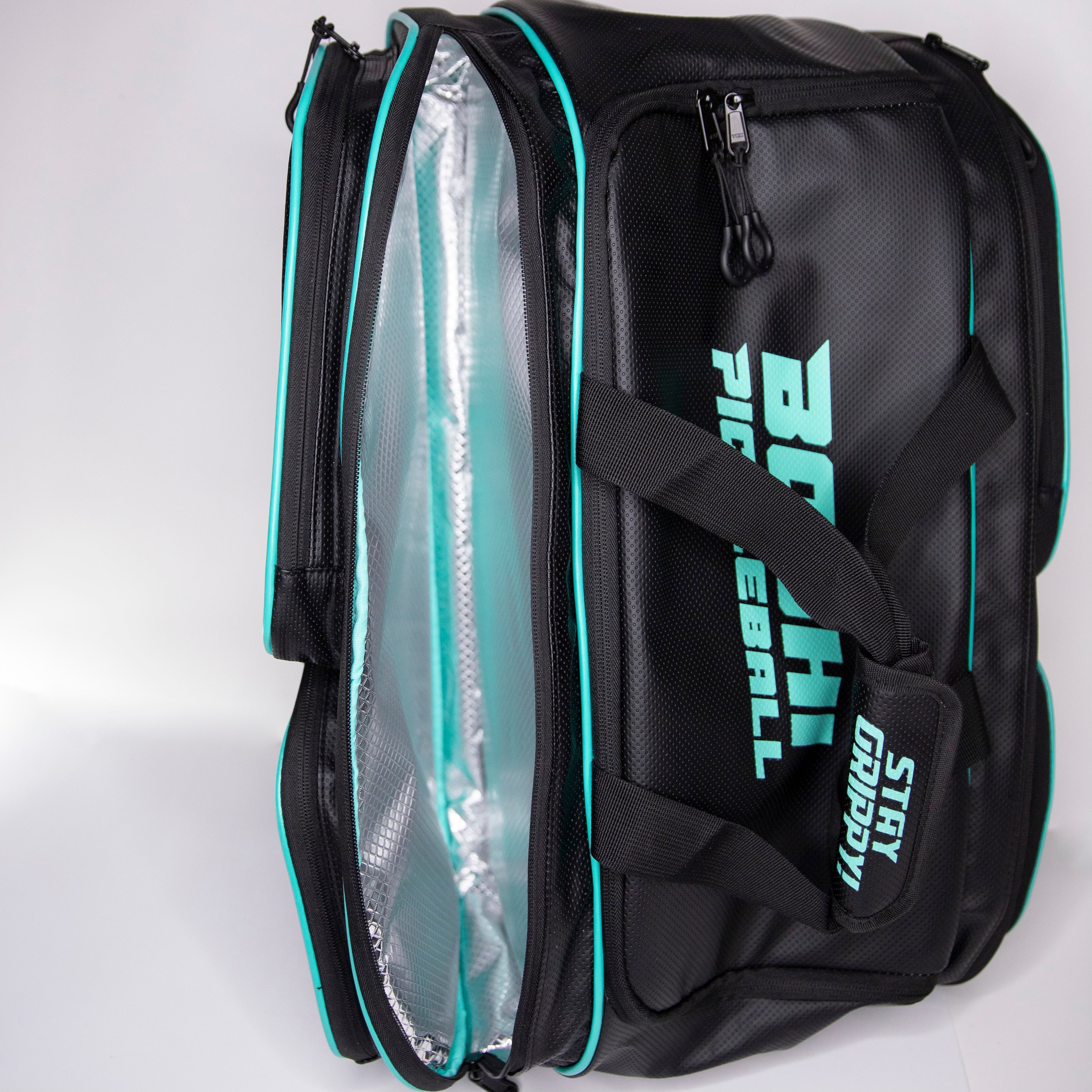Black and teal pickleball bag with an open compartment.