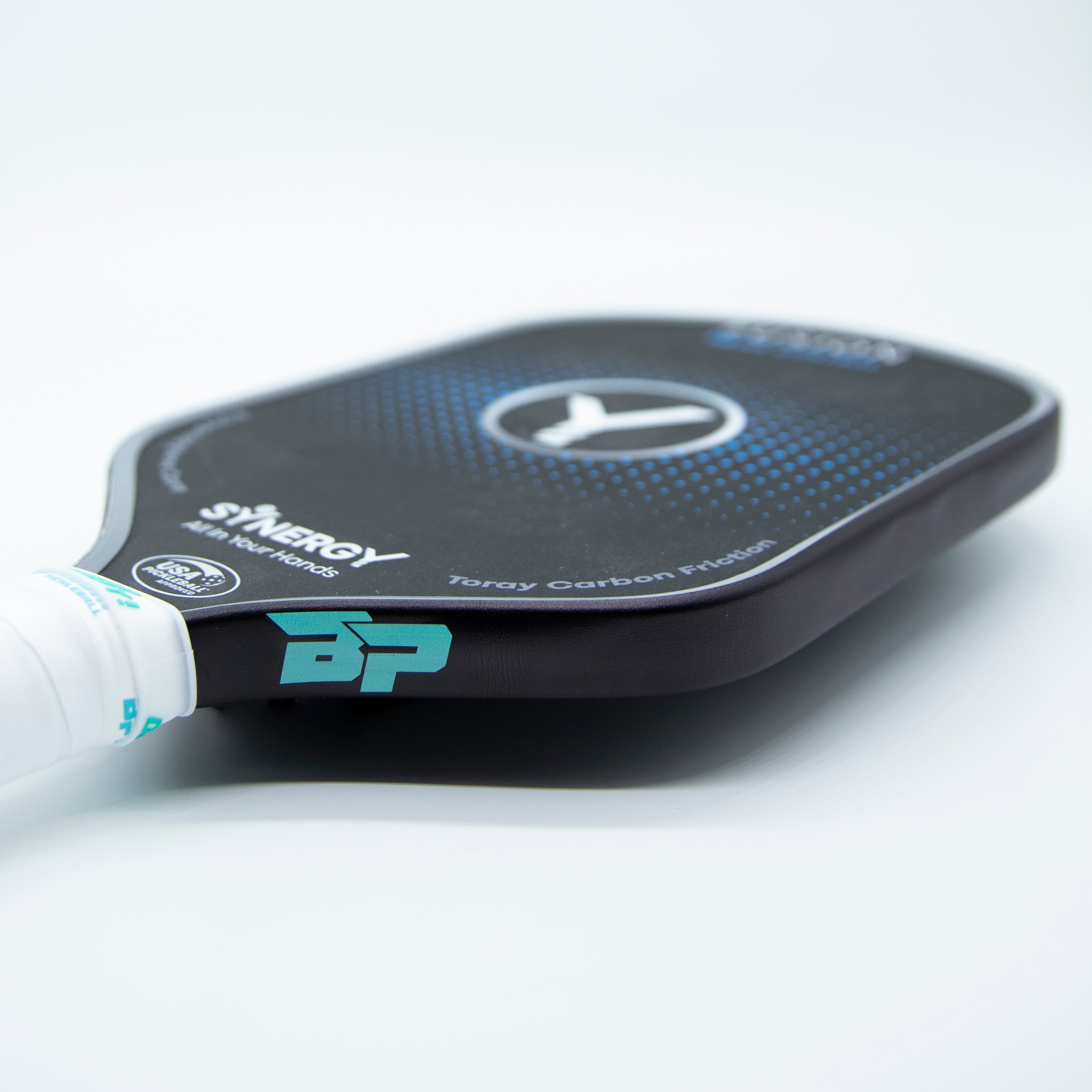 Close-up of a black pickleball paddle with blue and white accents.