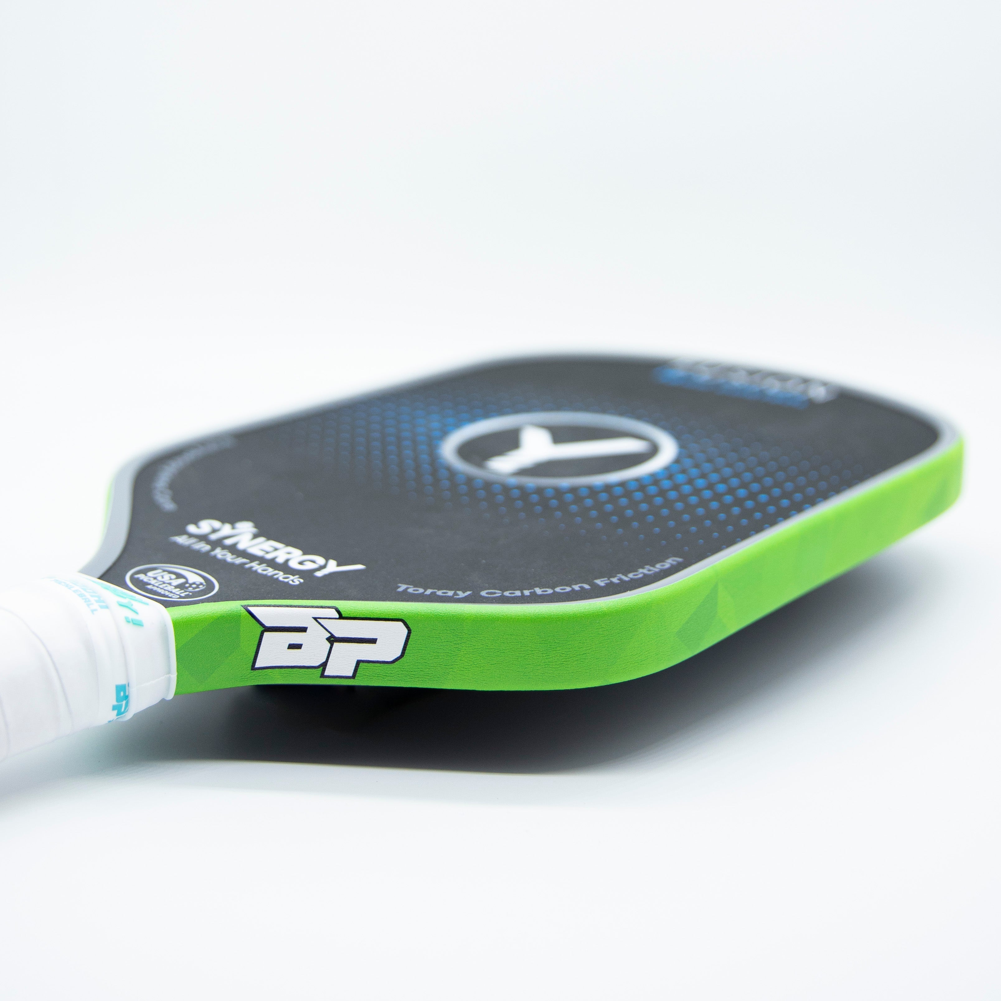 Close-up of a green and black pickleball paddle.
