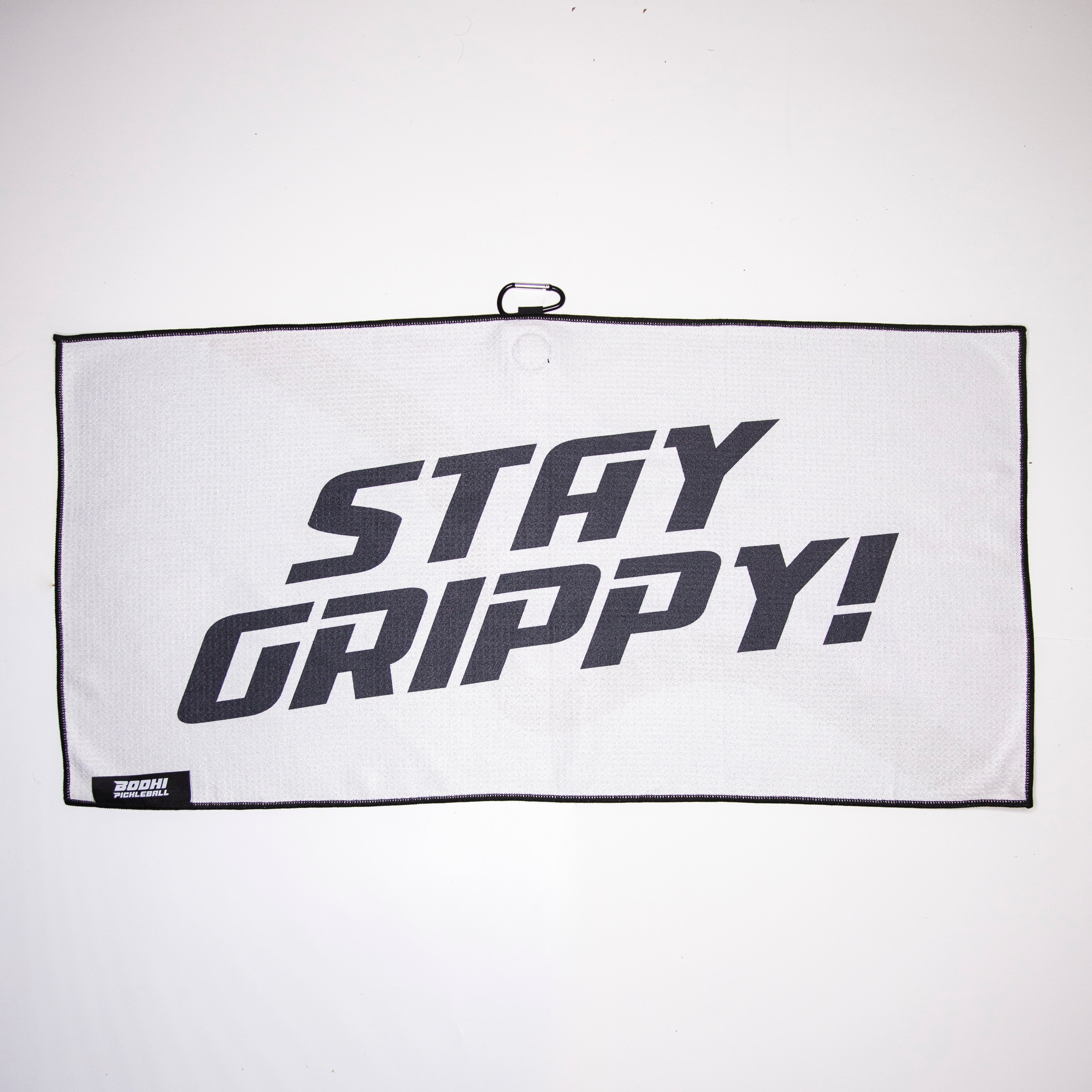 White towel with black trim and "STAY GRIPPY!" text.