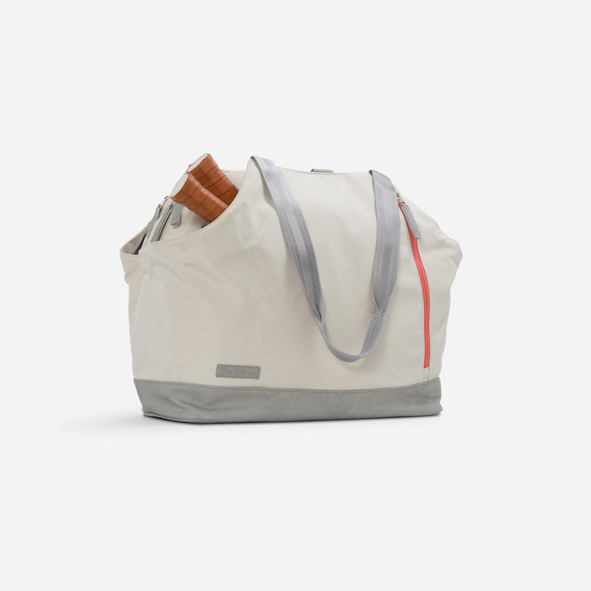 Off-white tennis tote bag with brown racket handles peeking out.