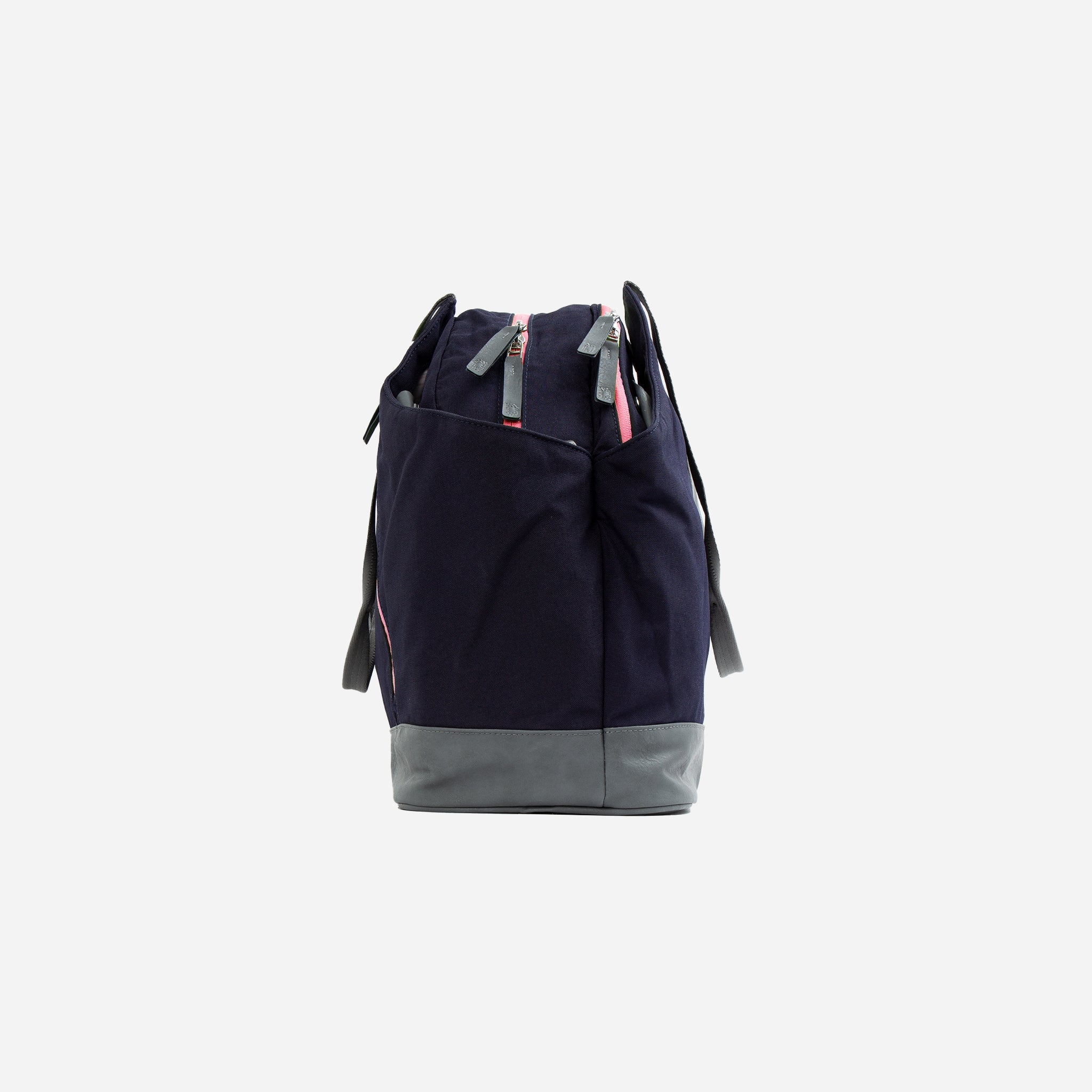 Navy blue fabric and gray faux leather pickleball duffel tote sport bag by Doubletake, with pink zippers, side view.