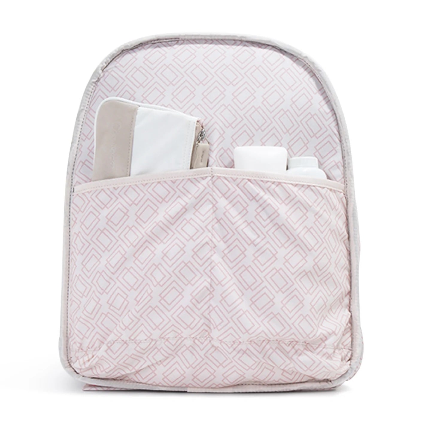 Pink geometric patterned interior of a tennis backpack and tote by Doubletake, with a pocket holding a beige pouch and two white bottles.