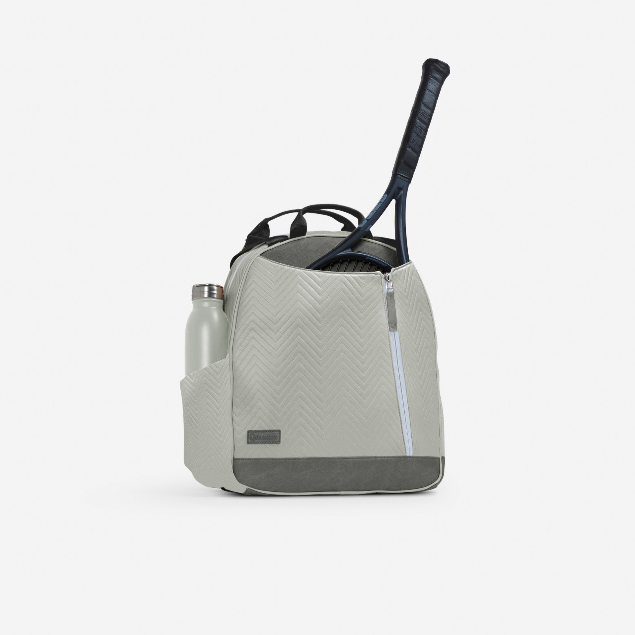 Light grey chevron quilted tennis backpack and tote bag by Doubletake, with a water bottle in a side pocket and a tennis racket inside.