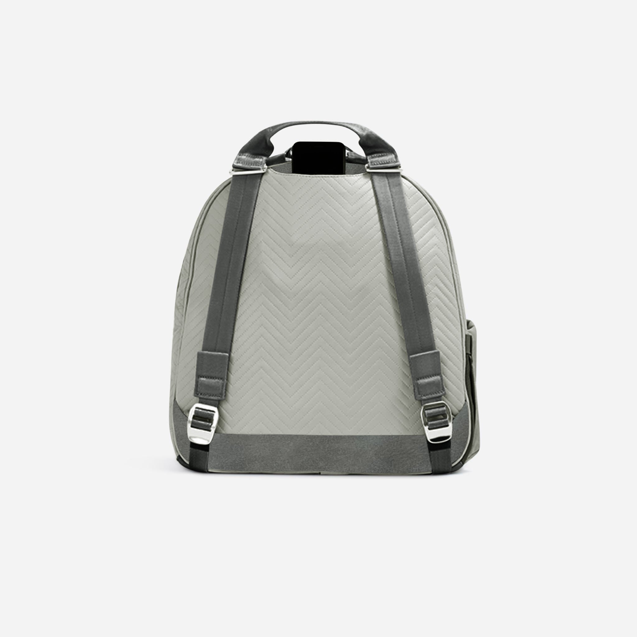 Light grey tennis backpack with chevron quilting by Doubletake, seen from the back, featuring dark grey straps and silver buckles, with a phone visible.