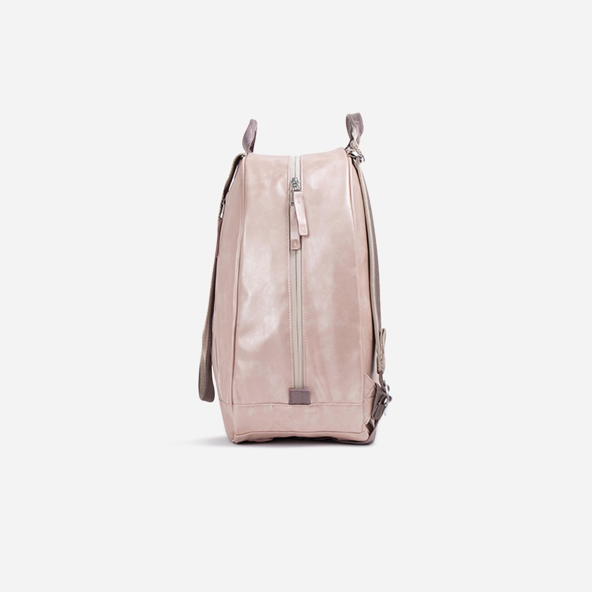 Blush pink Tennis Backpack & Tote by Doubletake in worn leather-look material with a front vertical zipper and top handles, side view.