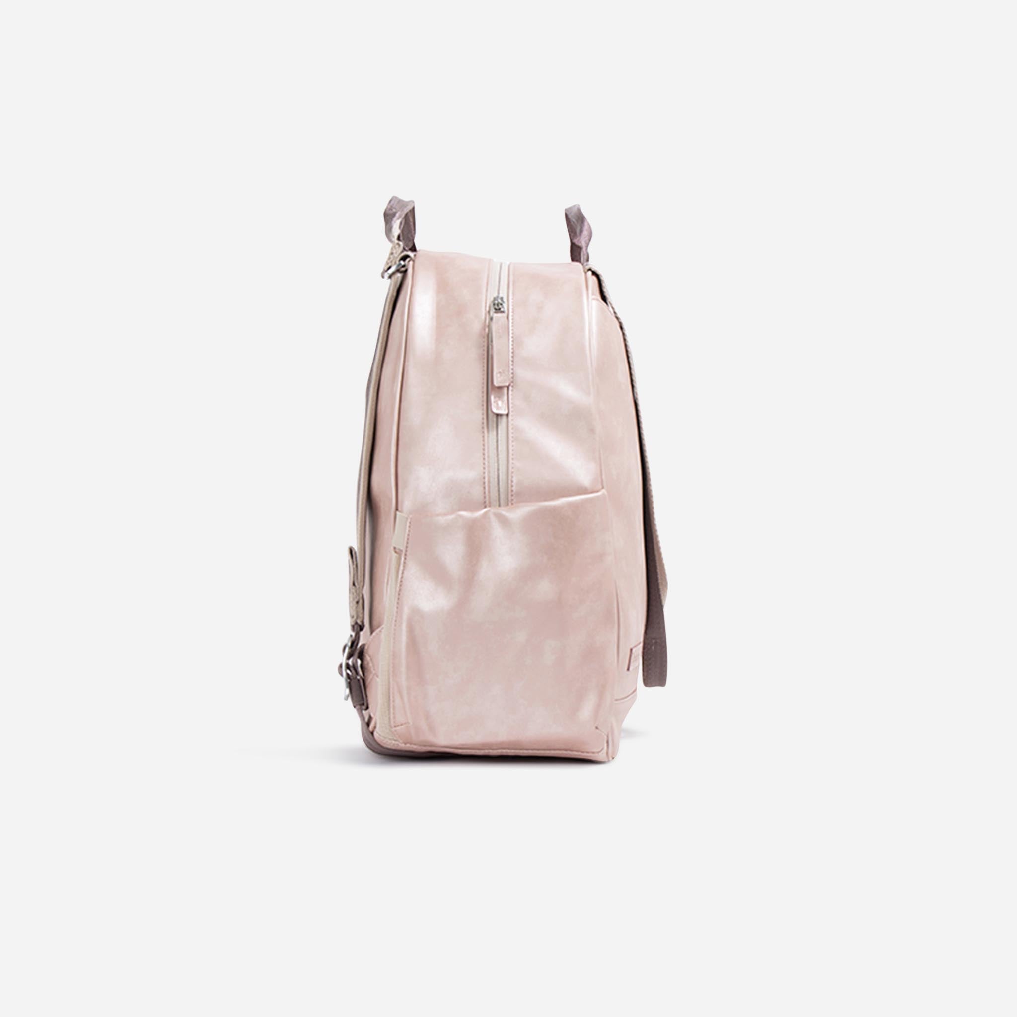 Light pink pickleball backpack by Doubletake, shown from a side angle, with a front zipper pocket and small top handles.