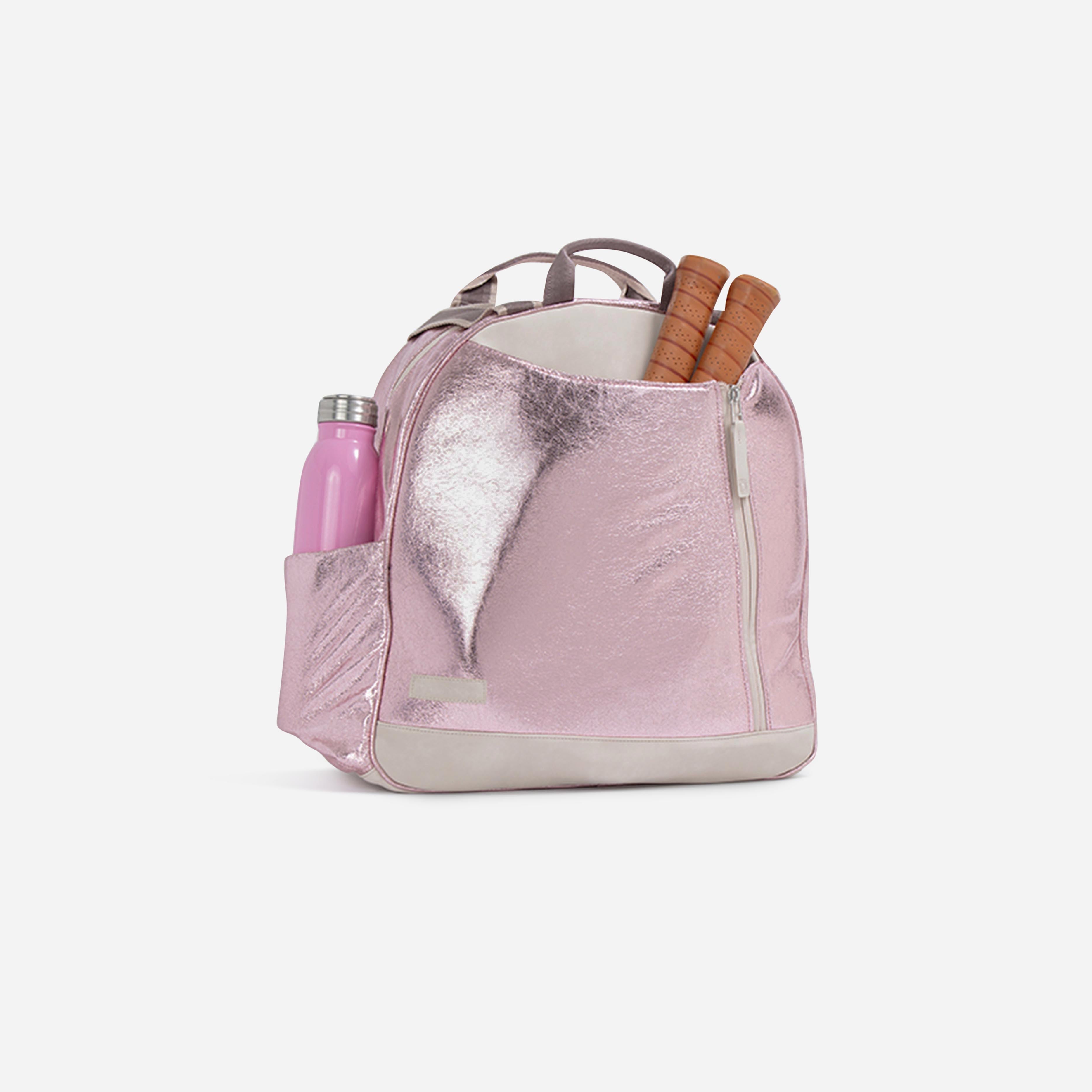 Shimmering metallic pink pickleball backpack by Doubletake, holding a pink water bottle and two pickleball paddles.