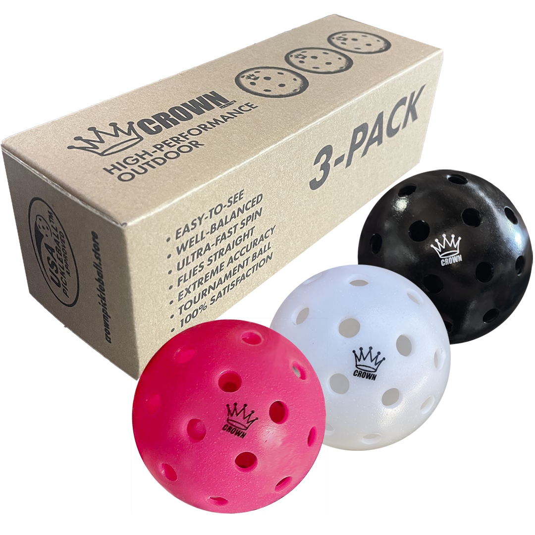 A three-pack of Crown pickleballs with a pink, white, and black ball, displayed with the cardboard packaging.