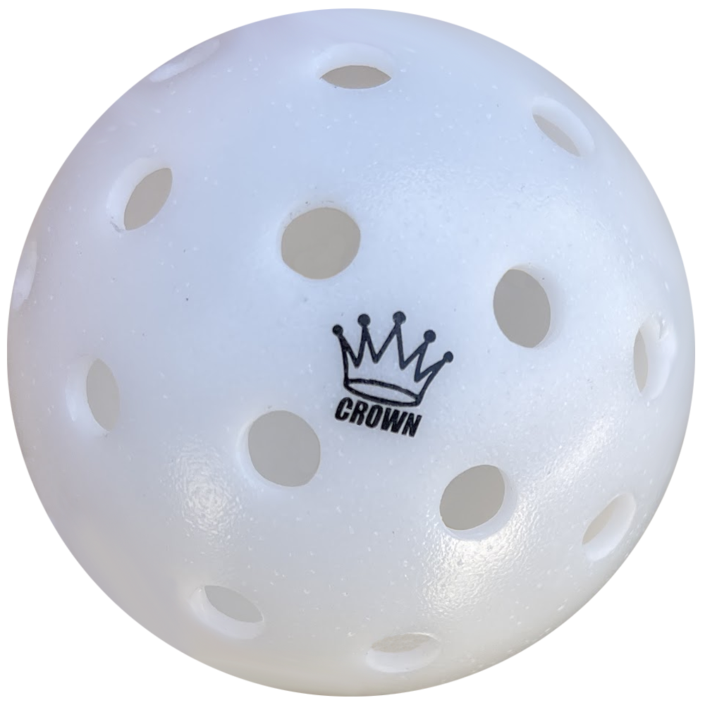 Close-up of a white pickleball with holes and a black "Crown" logo.
