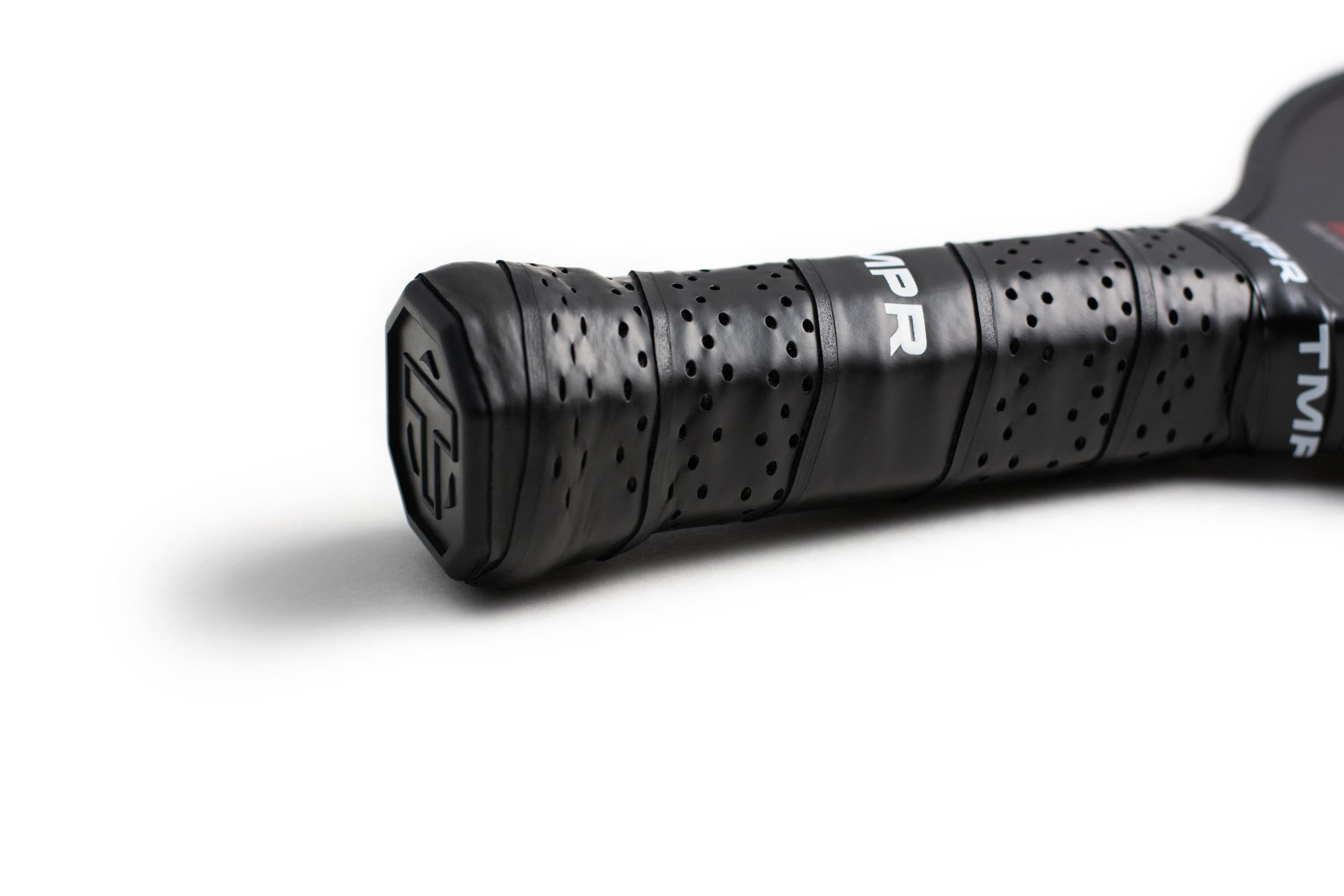 Black pickleball paddle handle by TMPR Sports with a perforated grip and brand logo.