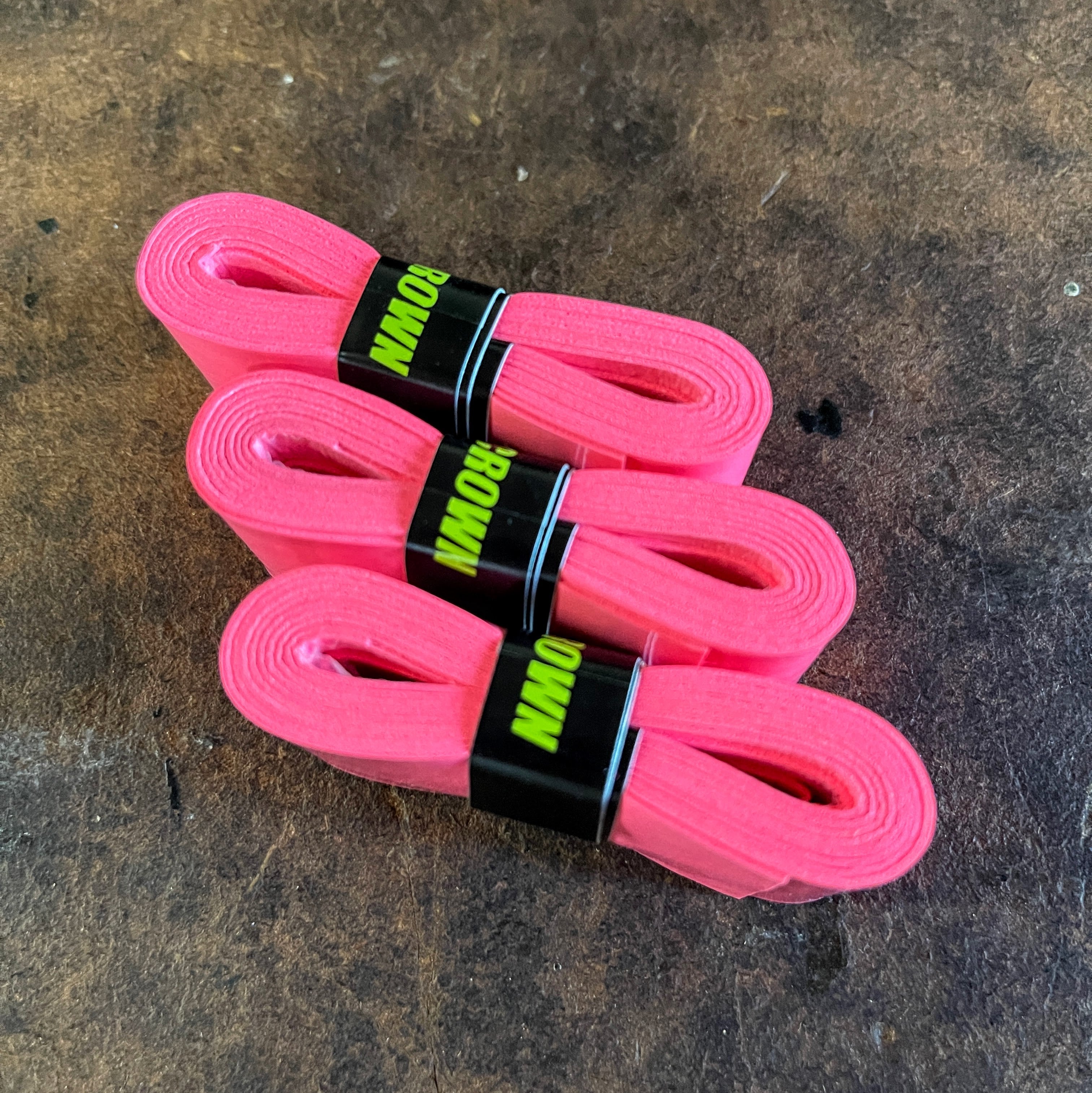 Three pink Rowen athletic tape rolls.