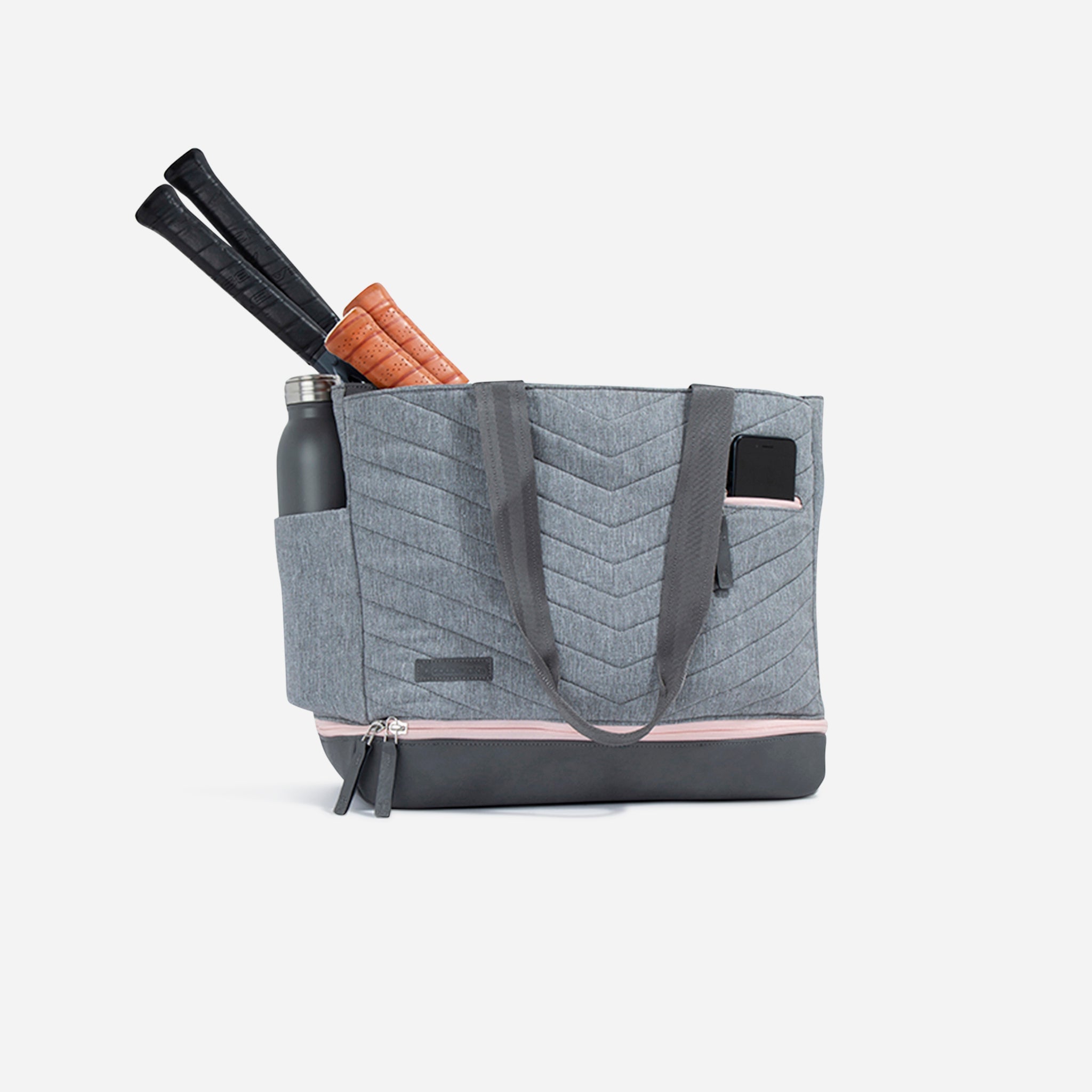 Gray quilted tote bag with water bottle and tennis racket handles.