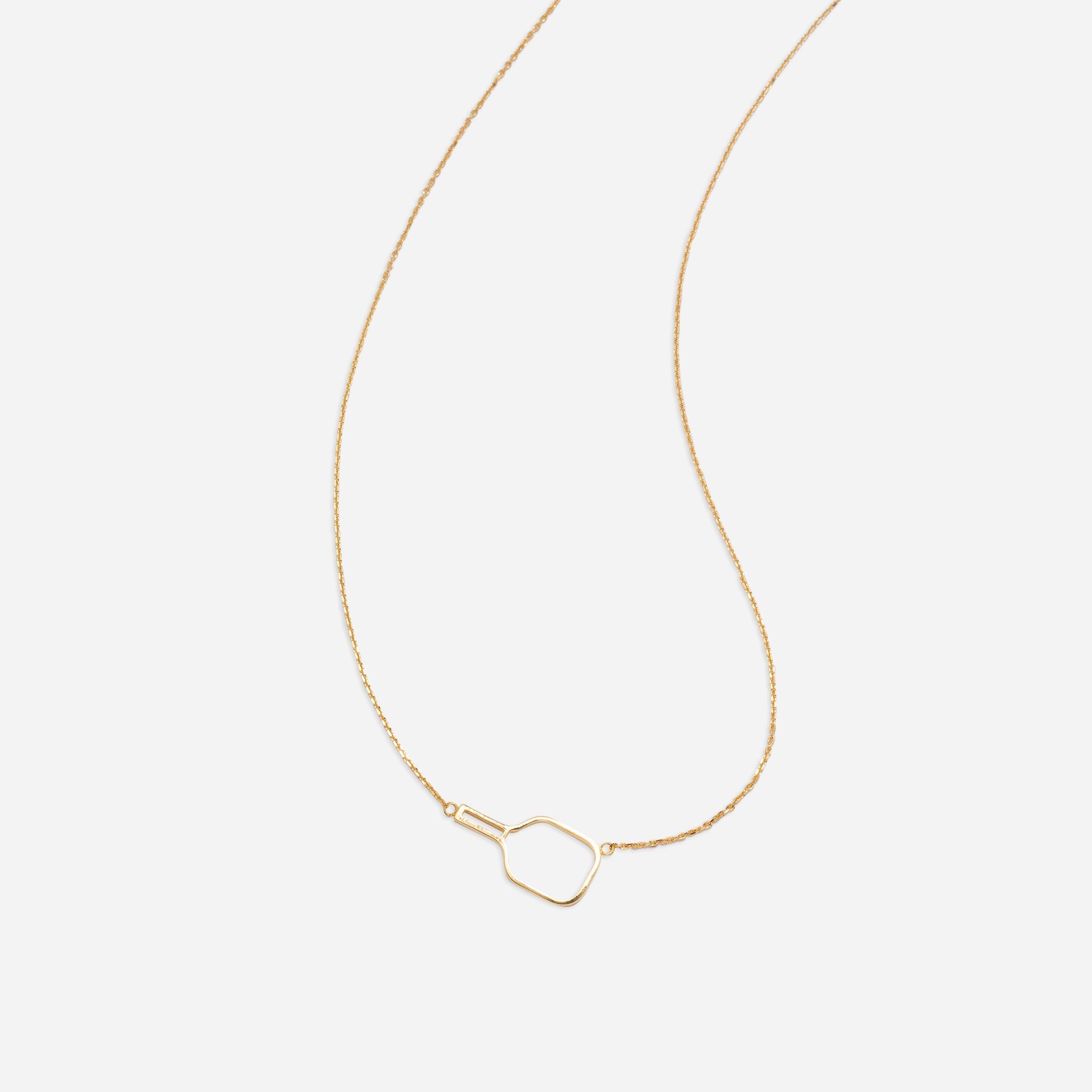 Gold necklace with paddle pendant on white background.